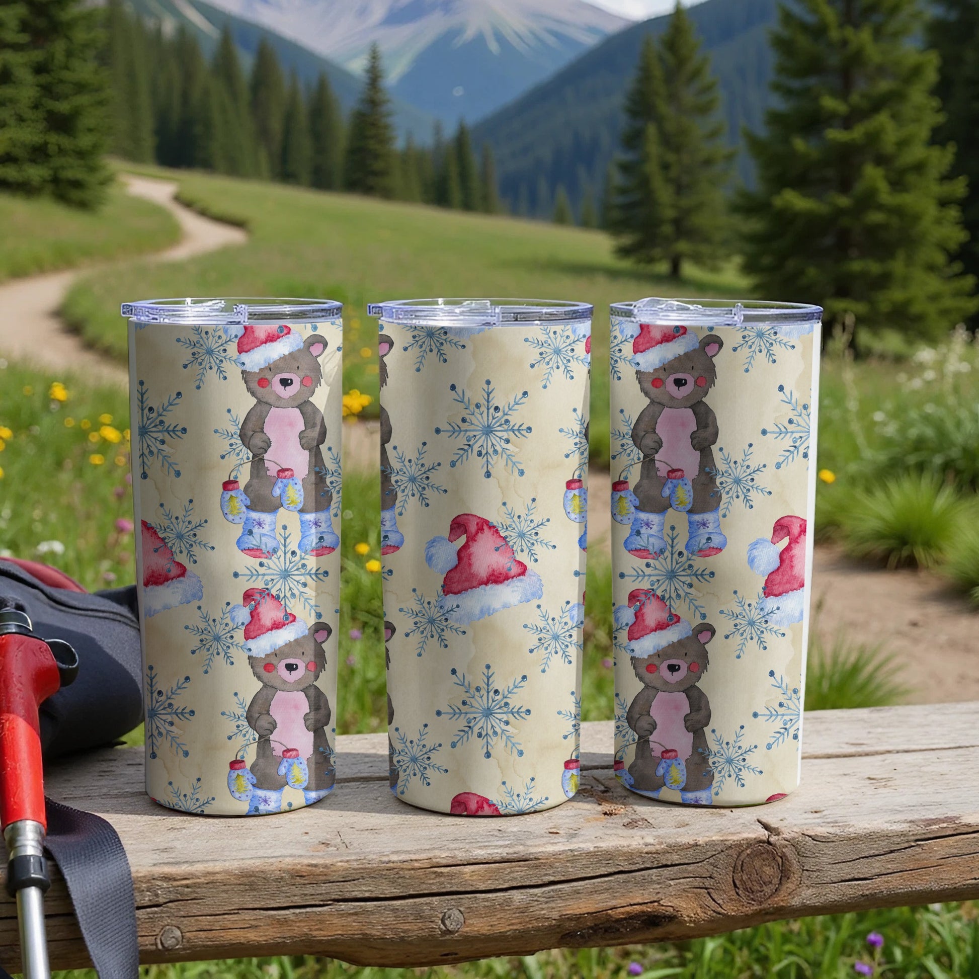 Three Santa hat-wearing bears with snowflakes on a ski resort path.