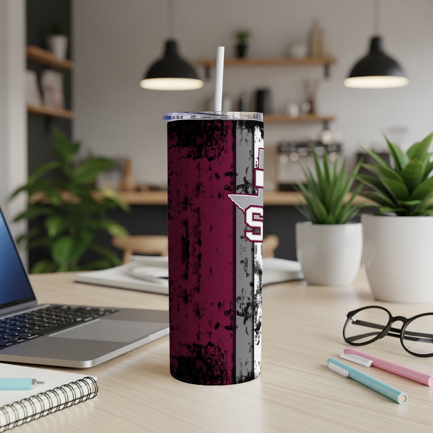 Maroon and gray distressed tumbler with white text and straw.