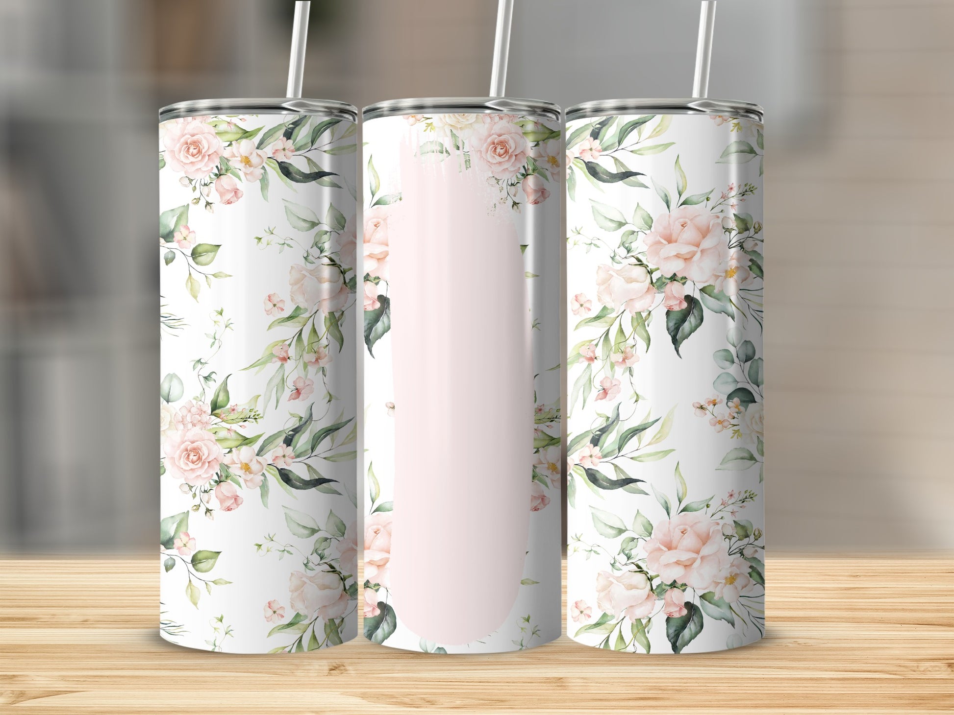 Three tall tumblers with a floral pattern of pink roses and green leaves.