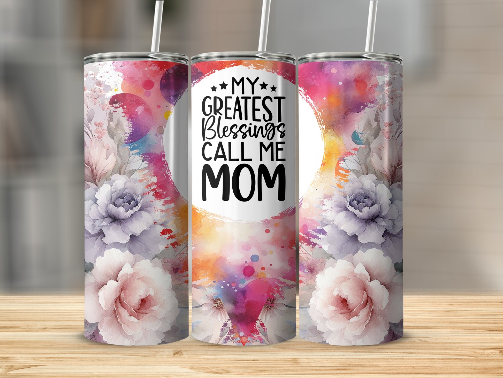 Floral tumbler with text "My Greatest Blessings Call Mom" on a wooden surface.