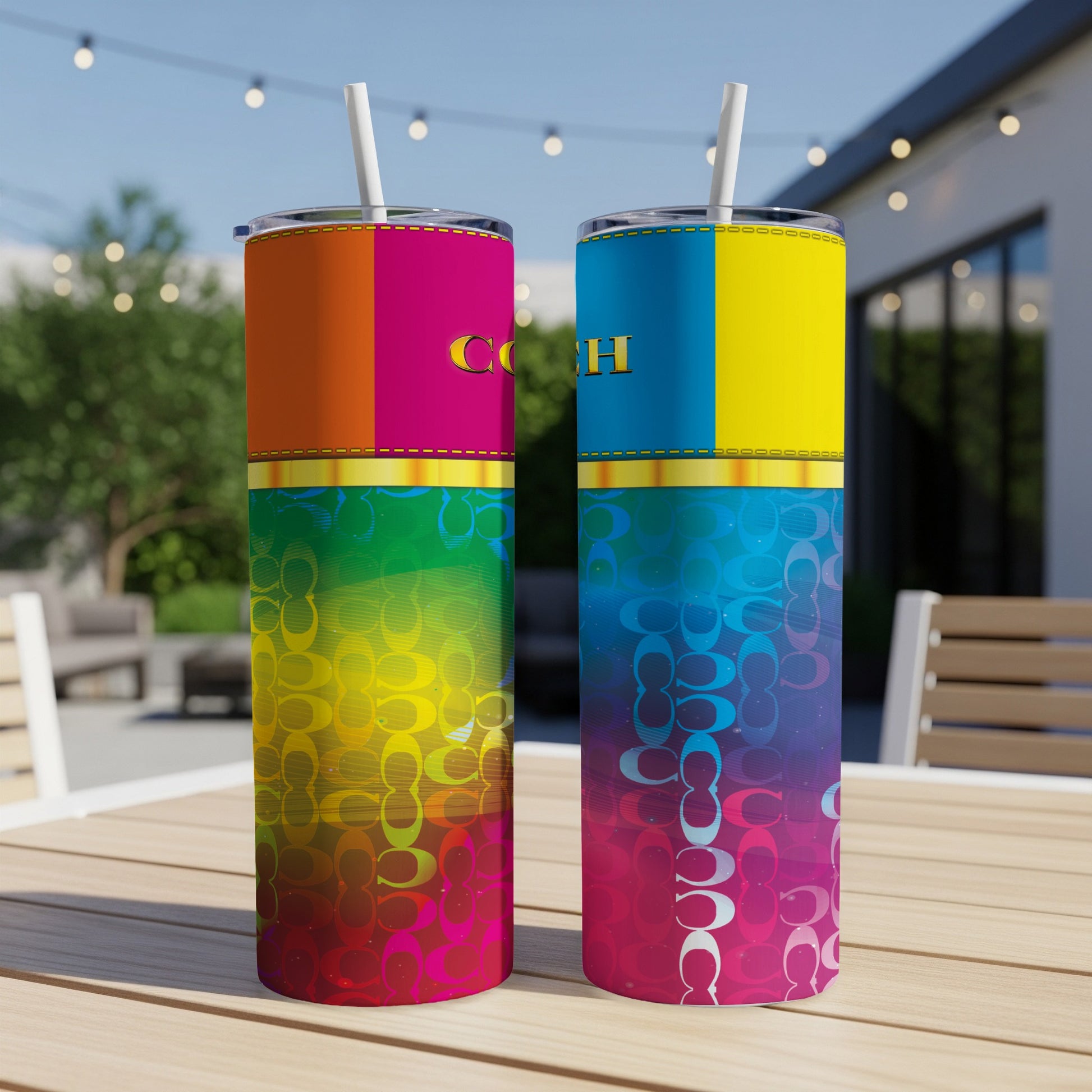 Two tumblers with colorful vertical stripes and "COACH" logos on a wooden table.