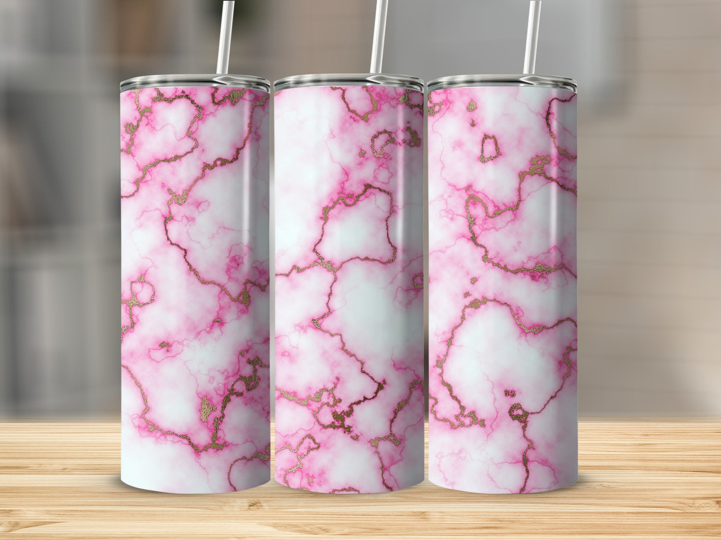 Three tumblers with pink and gold marble pattern and white straws.