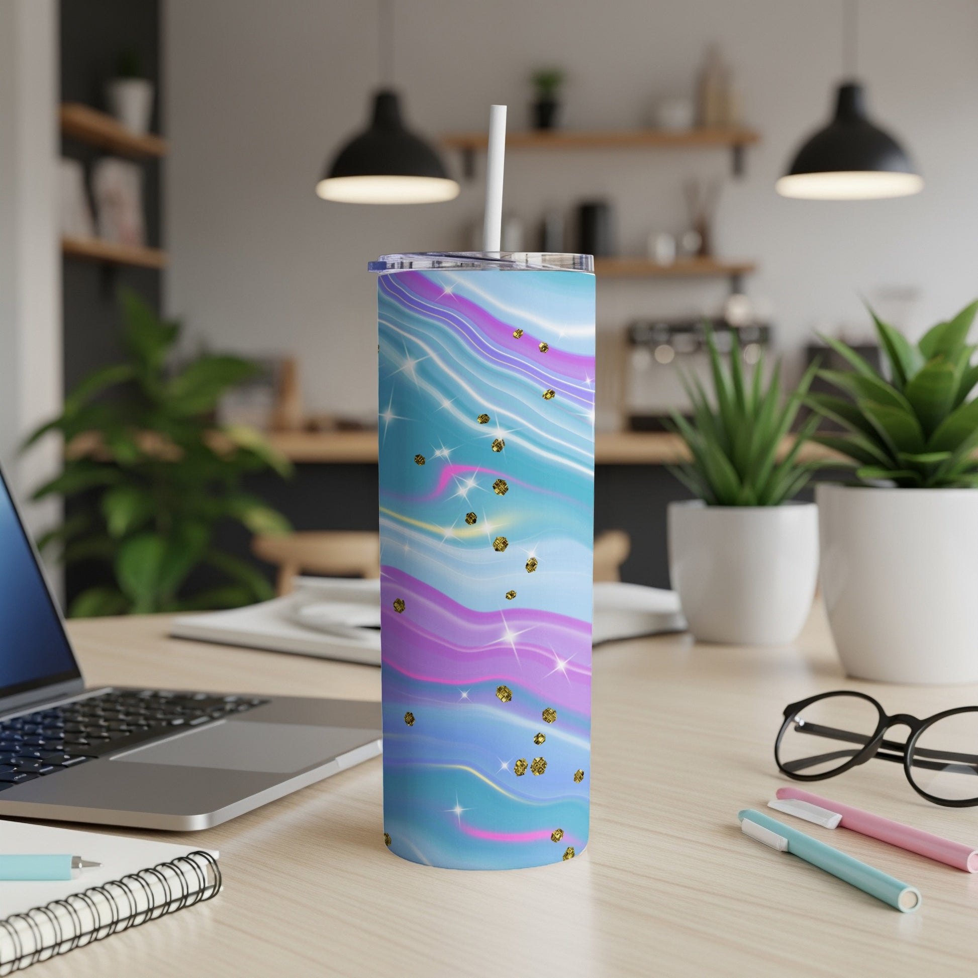 Tumbler with pastel swirl pattern and gold glitter accents, straw inserted.