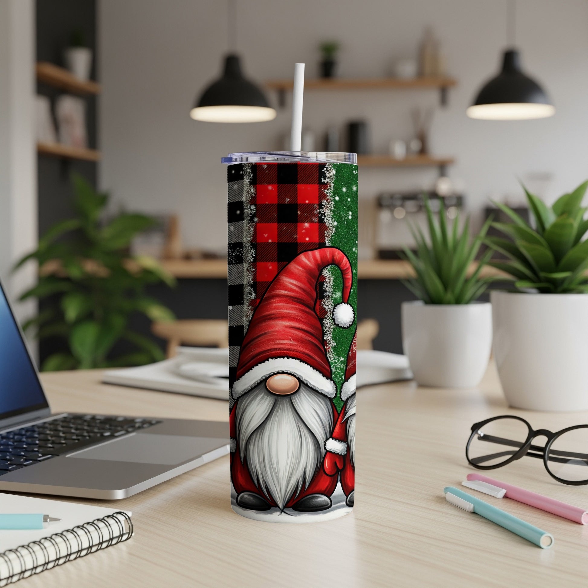 Two gnomes with red hats and white beards on a buffalo plaid tumbler.