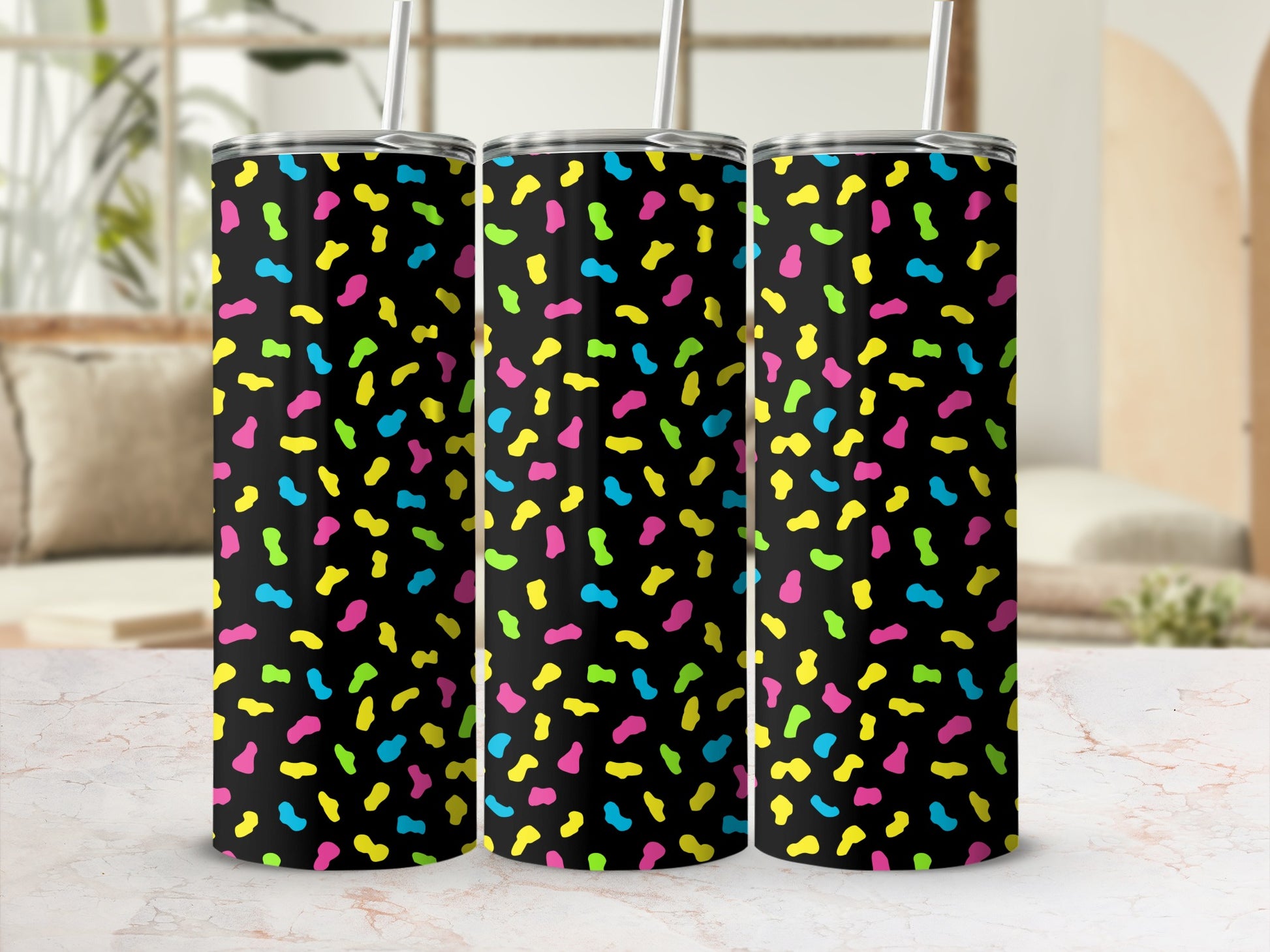 Three black tumblers with a confetti pattern of pink, yellow, and blue shapes.