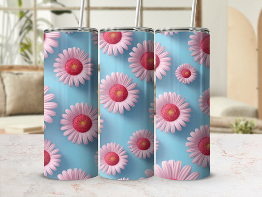 Three tumblers with pink and white daisies on a blue background.
