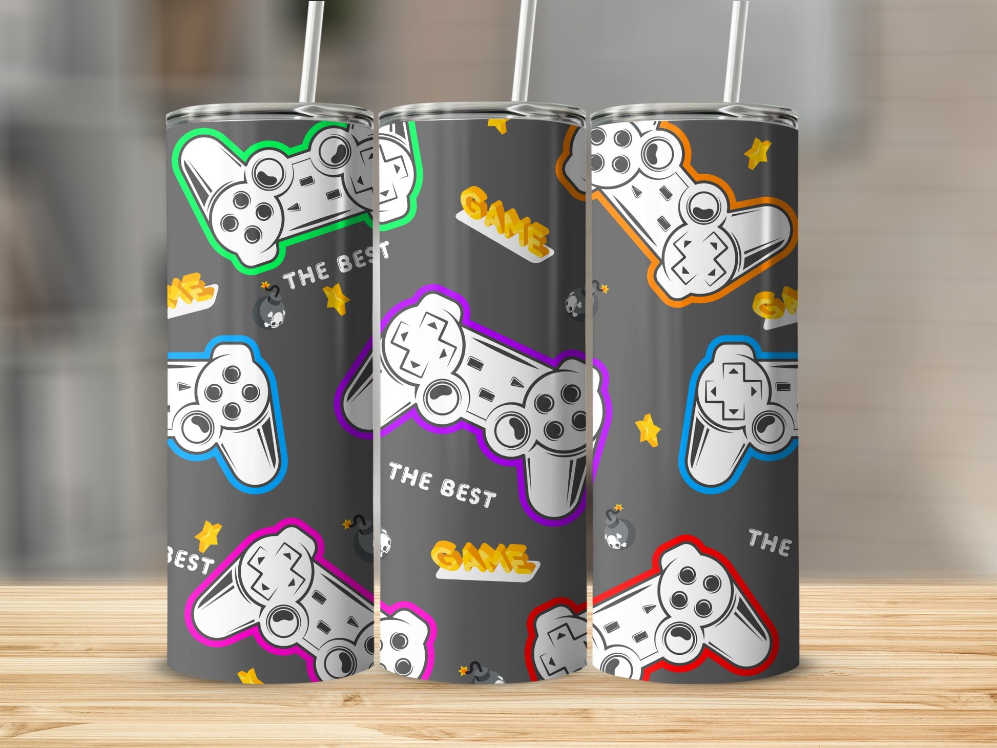 Three tumblers featuring a retro video game controller design with "The Best Game" text.