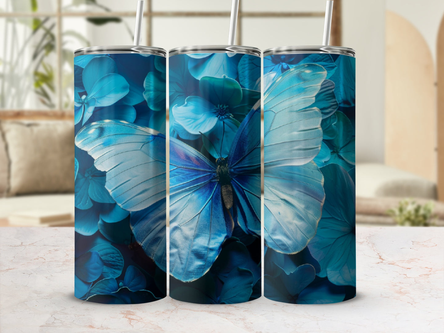 Blue butterfly and floral pattern on three tumblers.
