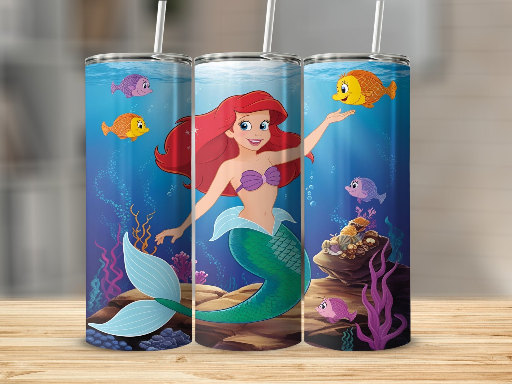 Ariel the mermaid with fish swimming around her in the ocean.