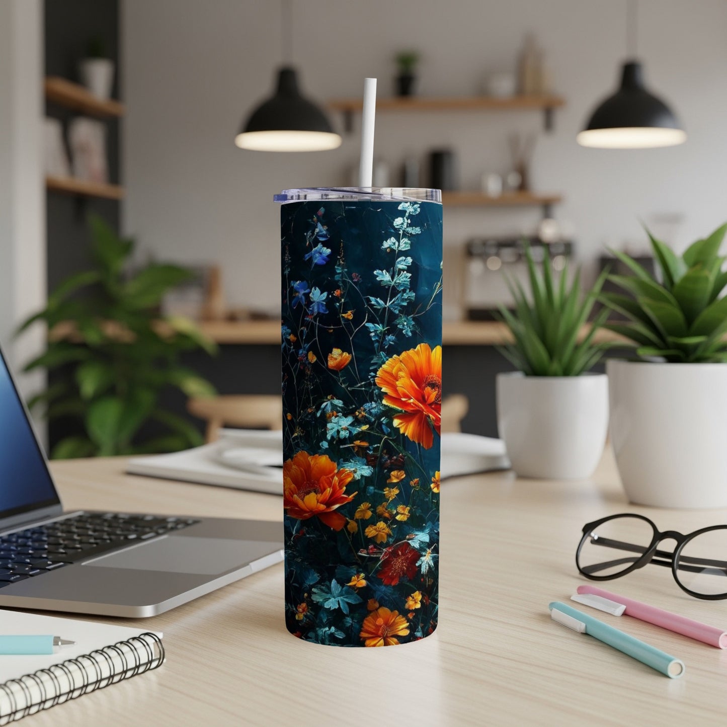 Tall tumbler with dark background and vibrant orange and blue floral design.