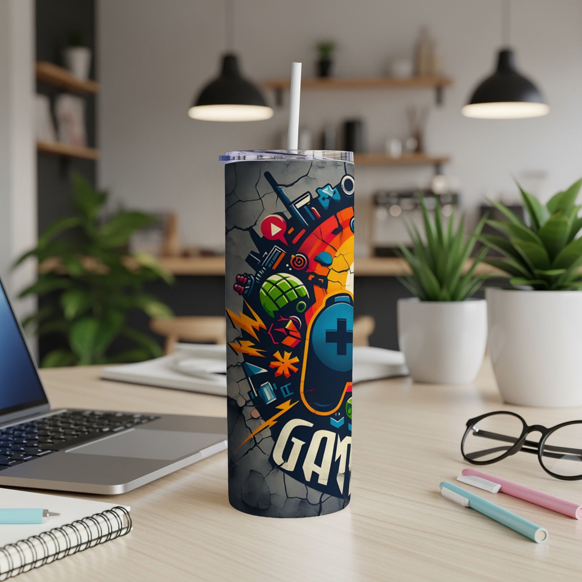 Gray tumbler with gaming icons and "GAMER" text, white straw.