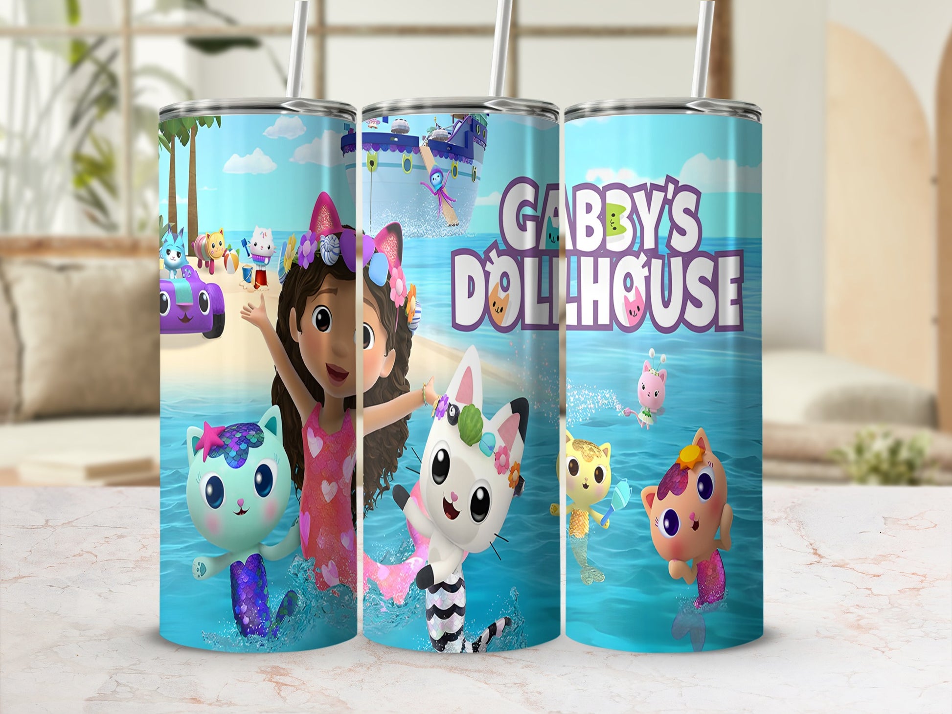 Gabby's Dollhouse characters on a blue tumbler with a straw.