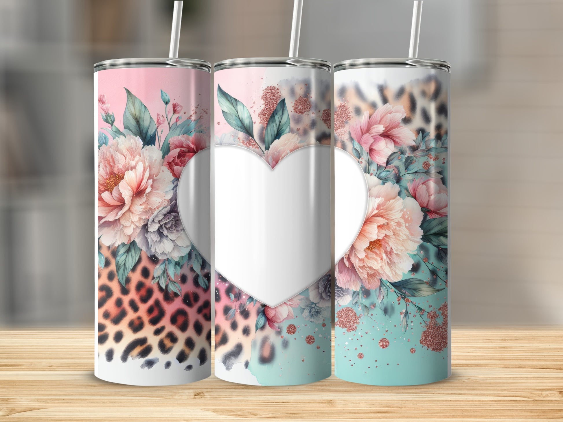 Three tall tumblers with floral and leopard print designs.