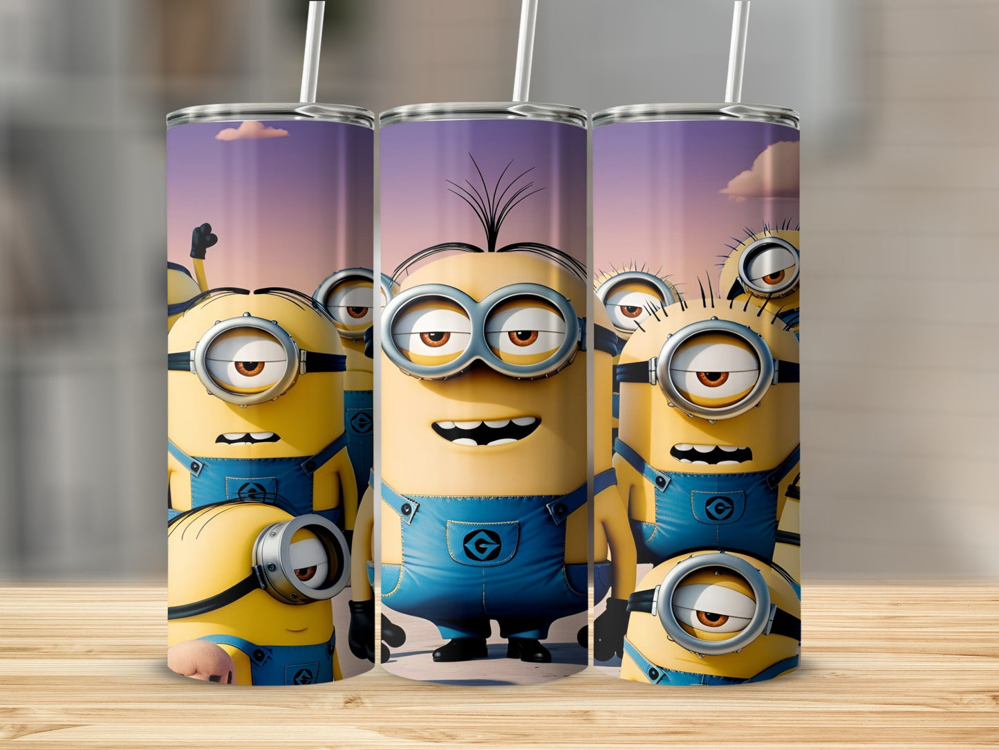Three Minions tumblers with straw standing upright on a wooden surface.