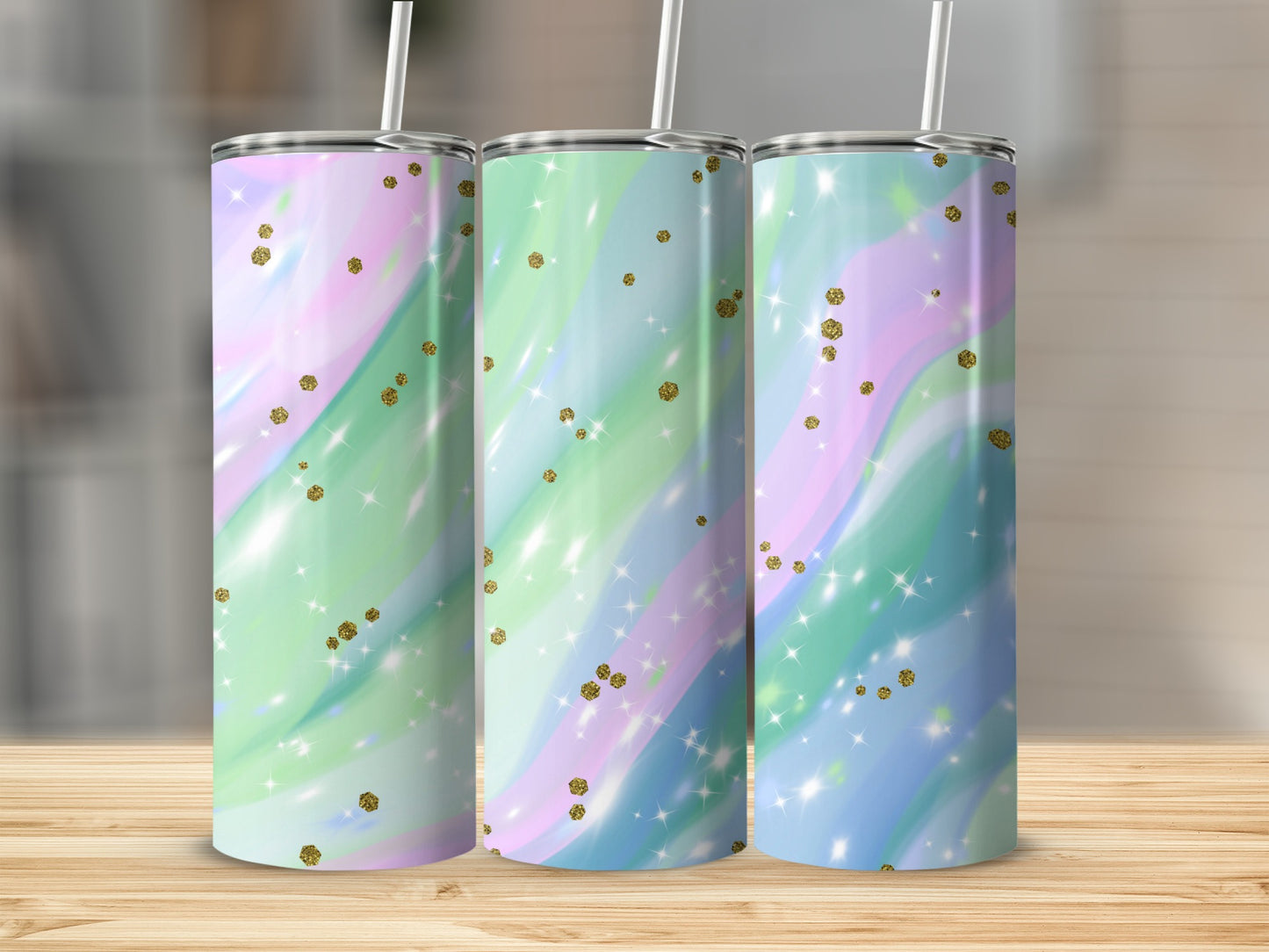 Three tumblers with swirling pastel colors and glitter accents.