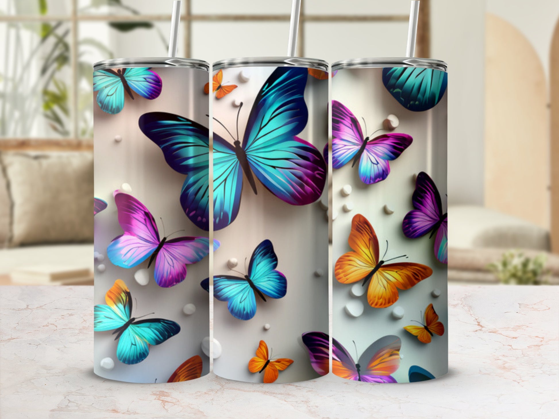 Three tumblers featuring colorful butterflies on a textured background.