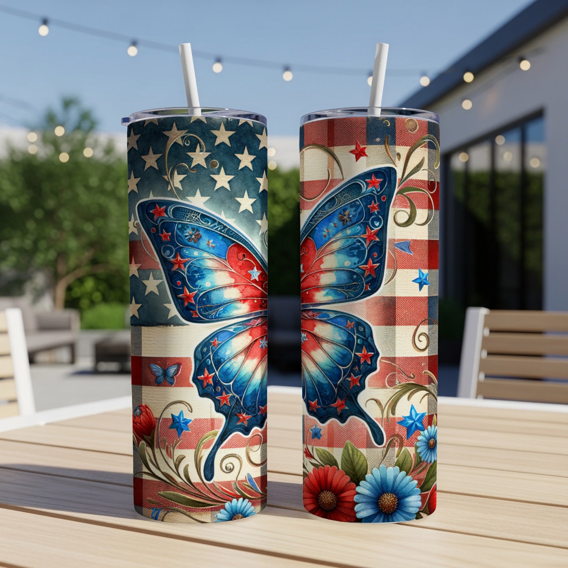 Two patriotic tumblers featuring a large butterfly and floral designs on a wooden table.