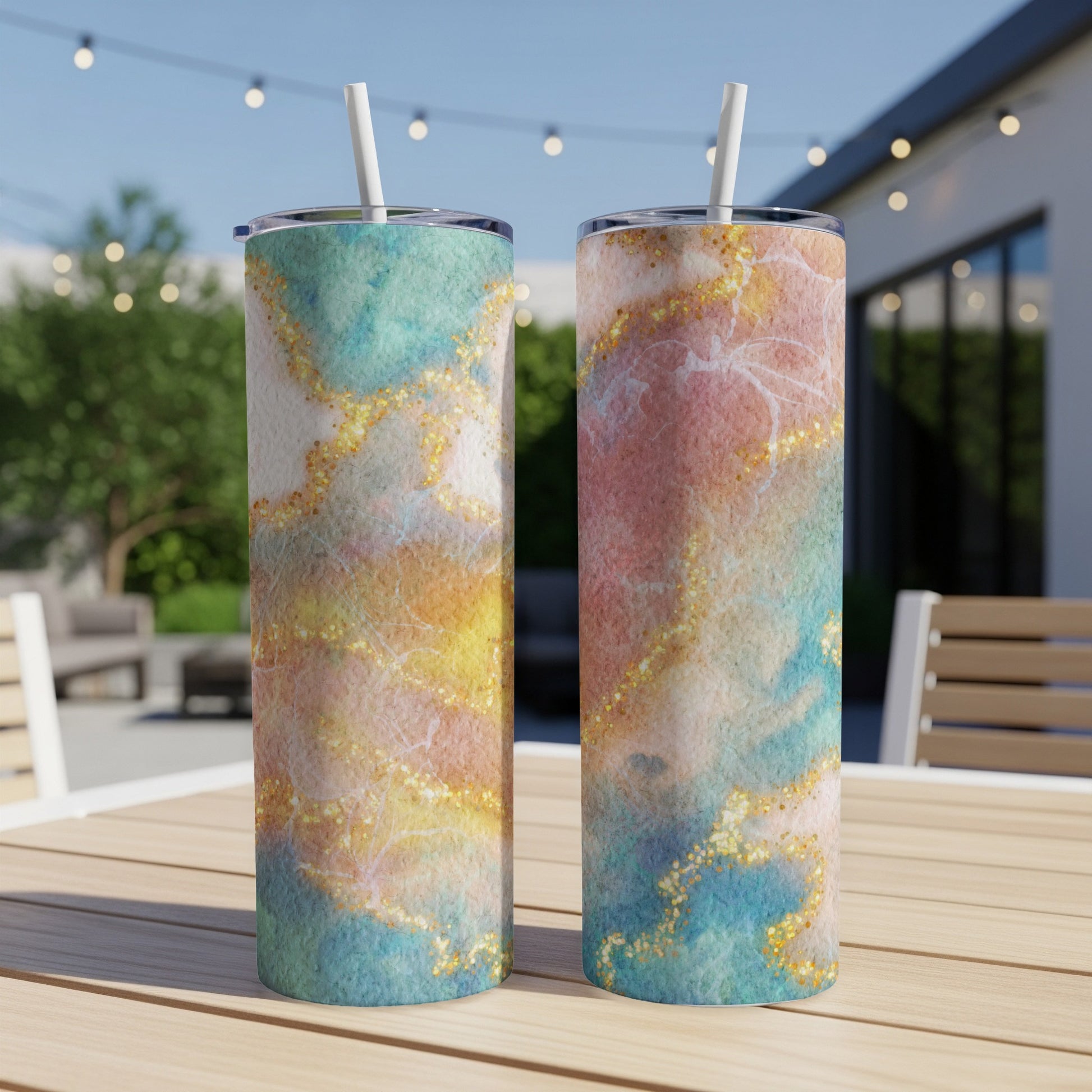 Two tumblers with marble watercolor designs and gold glitter accents.