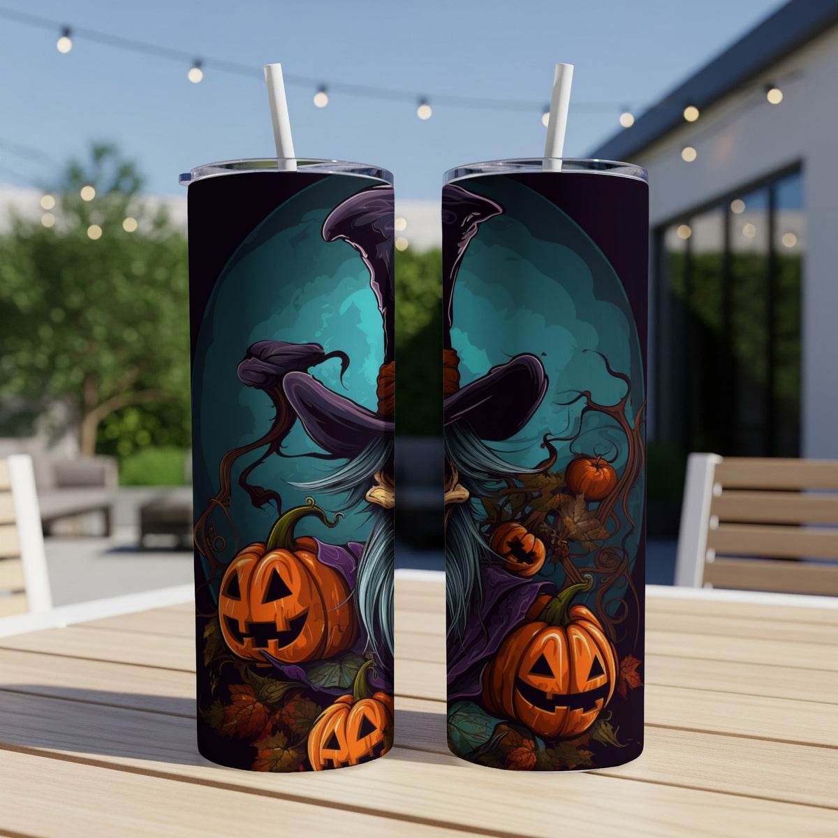 Two Halloween tumblers with a witch and pumpkins design on a patio table.