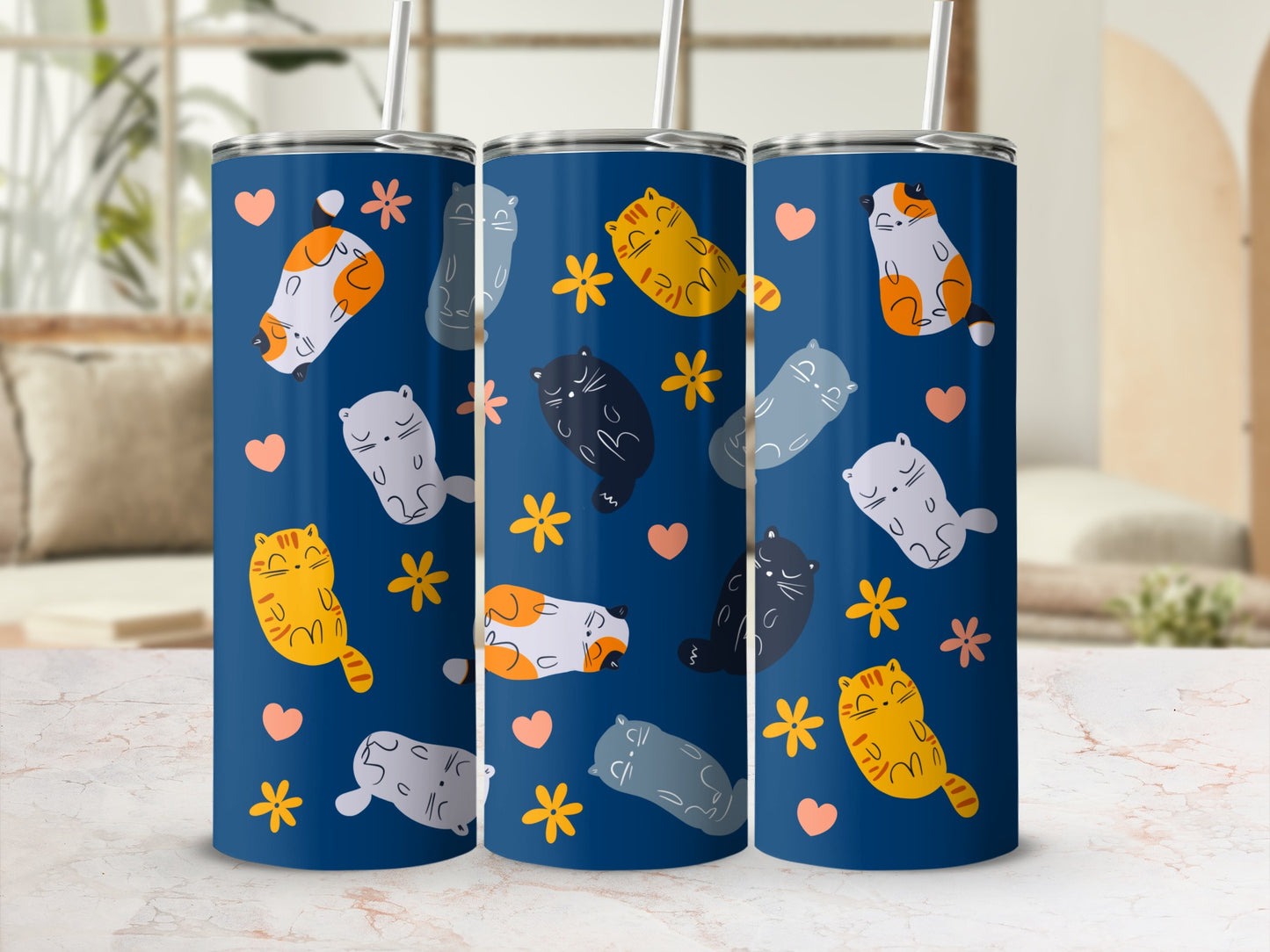Three blue tumblers featuring a repeating pattern of cute cats and flowers.