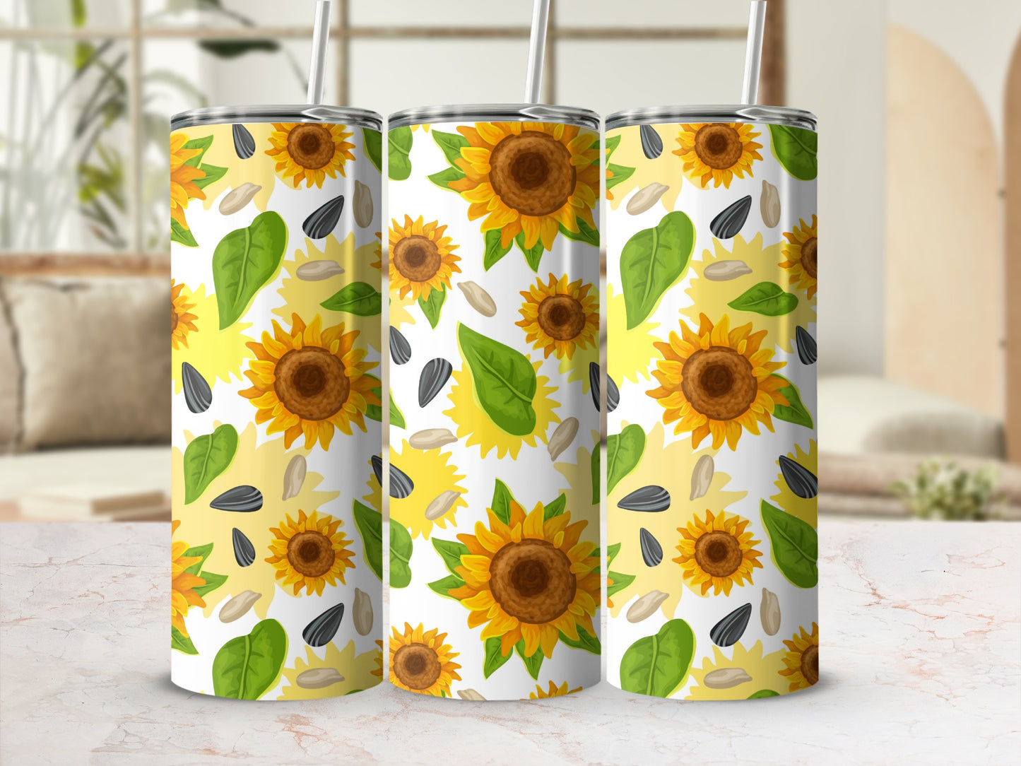 Three tumblers with a repeating pattern of sunflowers, leaves, and seeds.