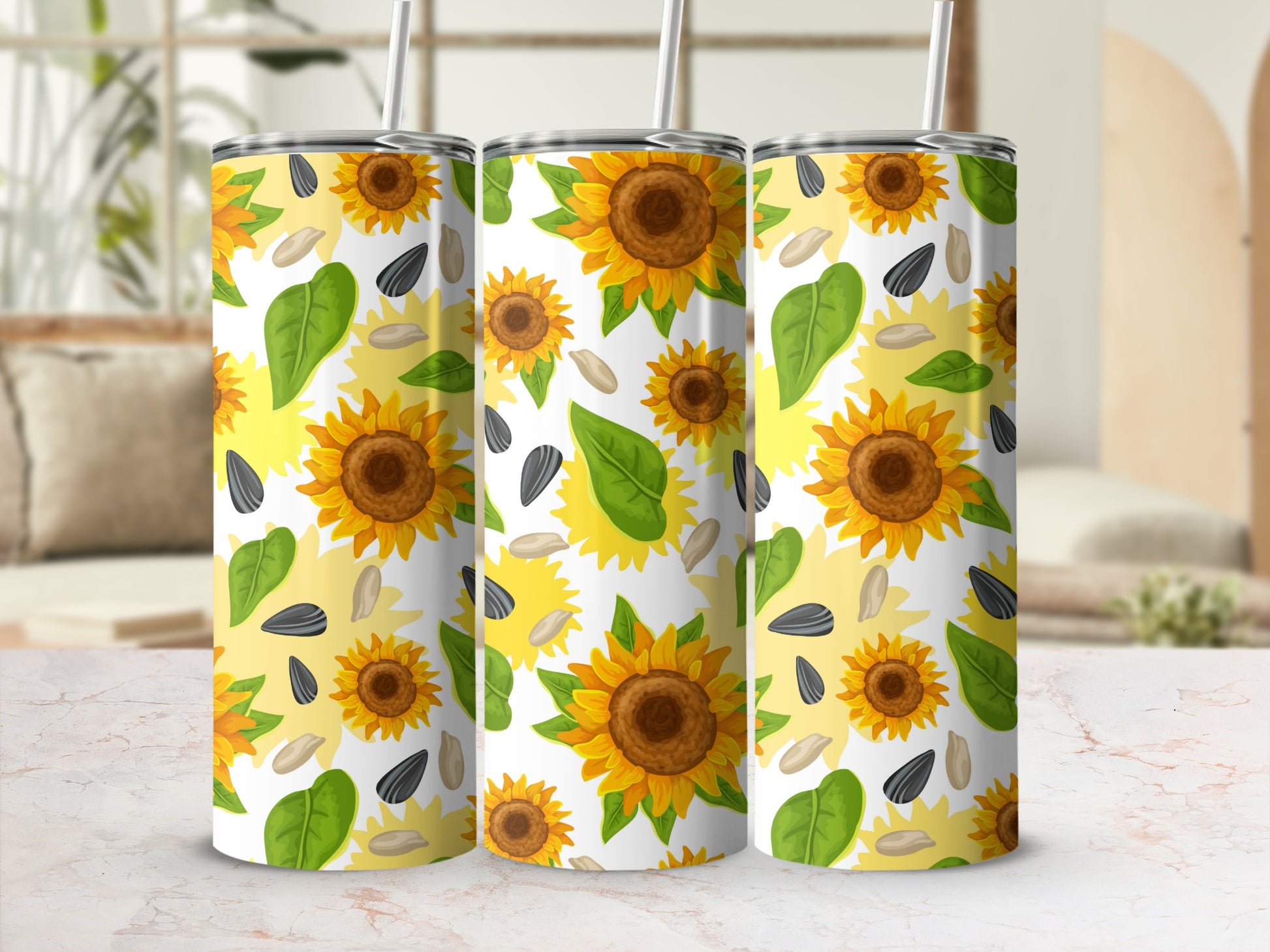 Three tumblers with a repeating pattern of sunflowers, leaves, and seeds.