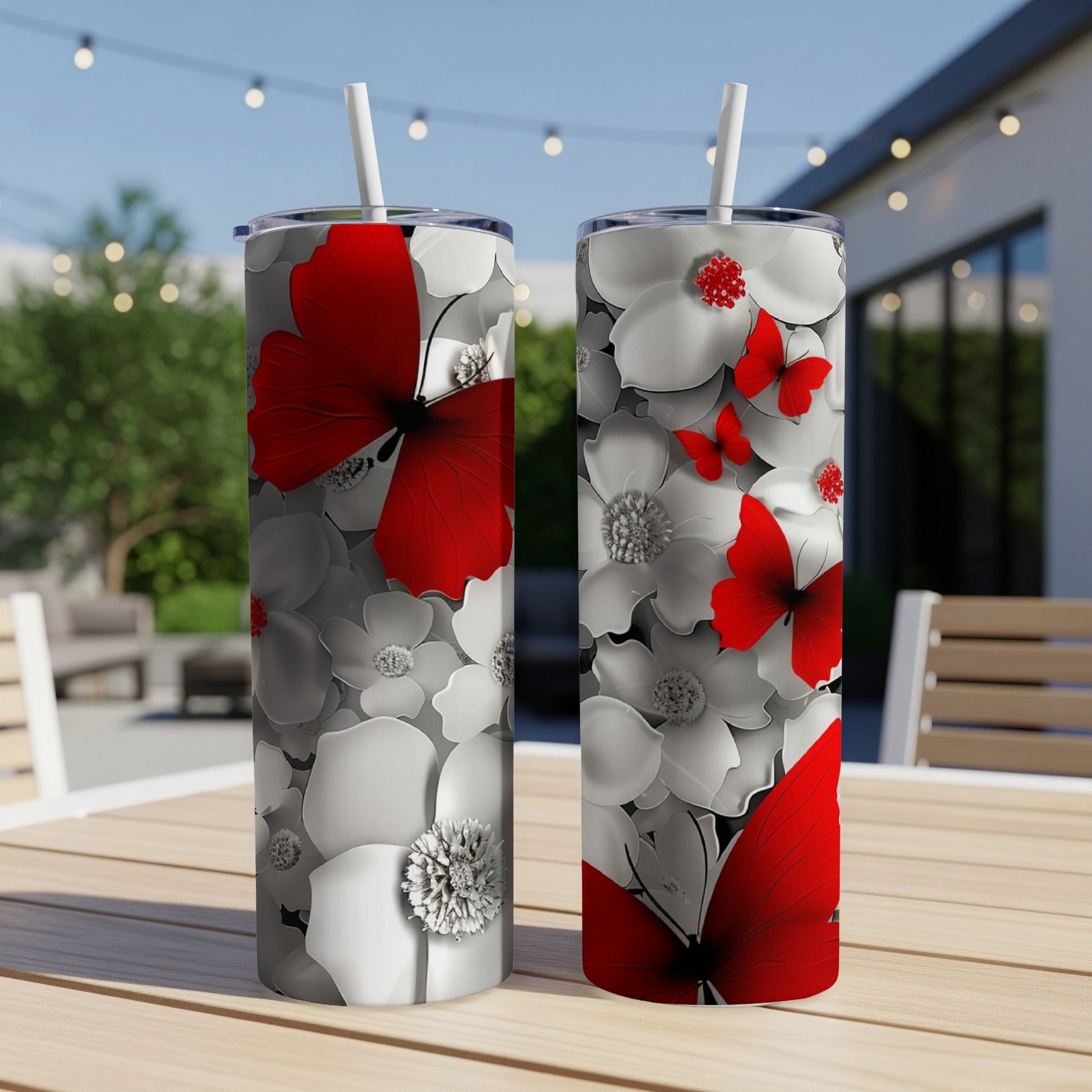 Two tumblers with red butterflies and white flowers.
