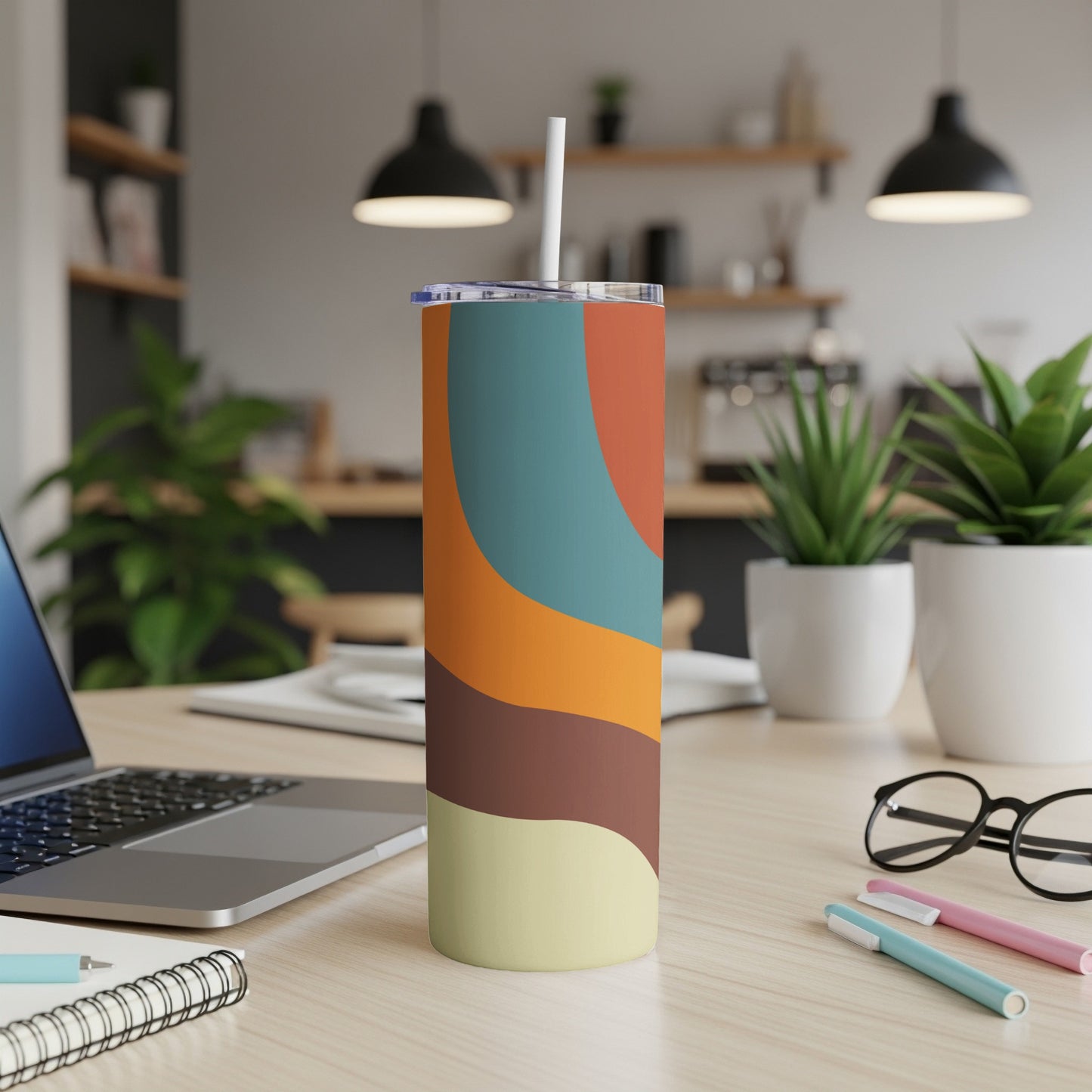 Tumbler with abstract curved stripes in tan, brown, orange, blue, and rust.