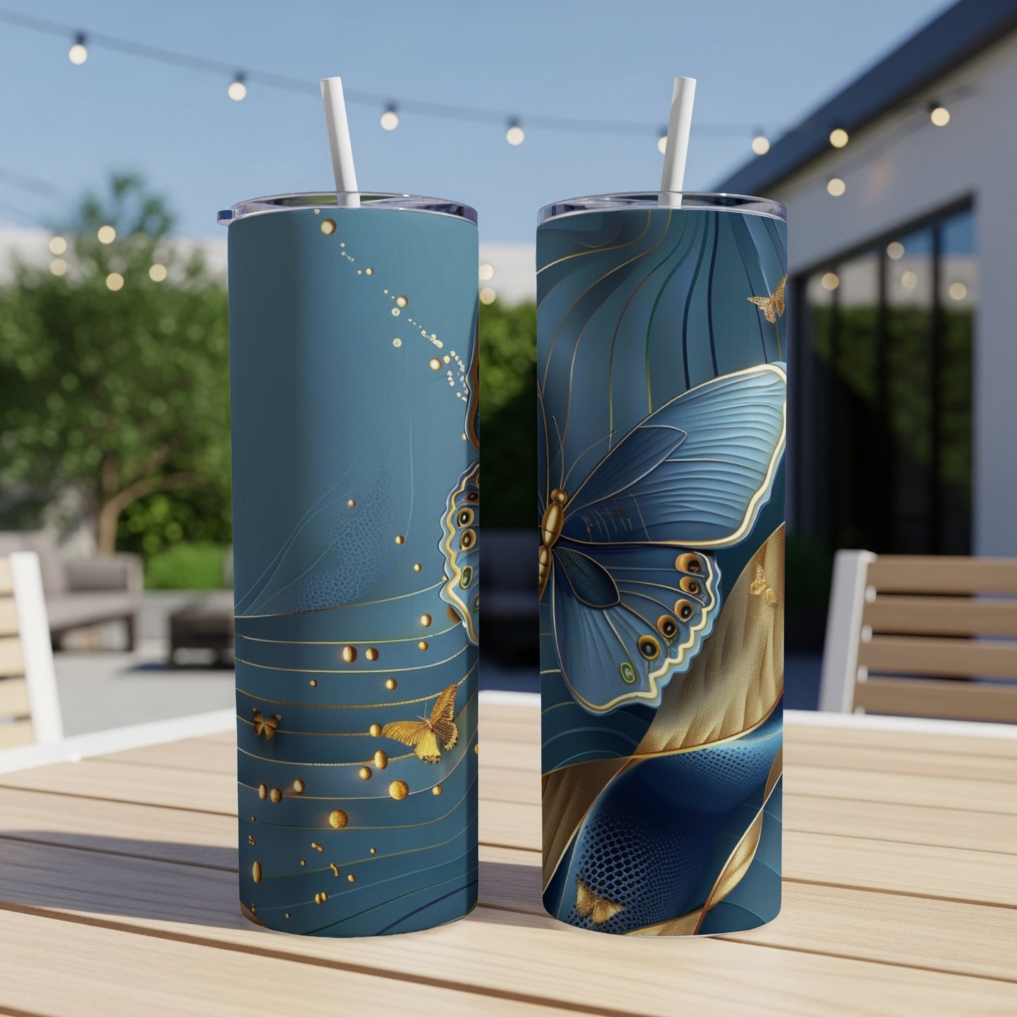 Two tall tumblers with blue and gold butterfly and floral designs.