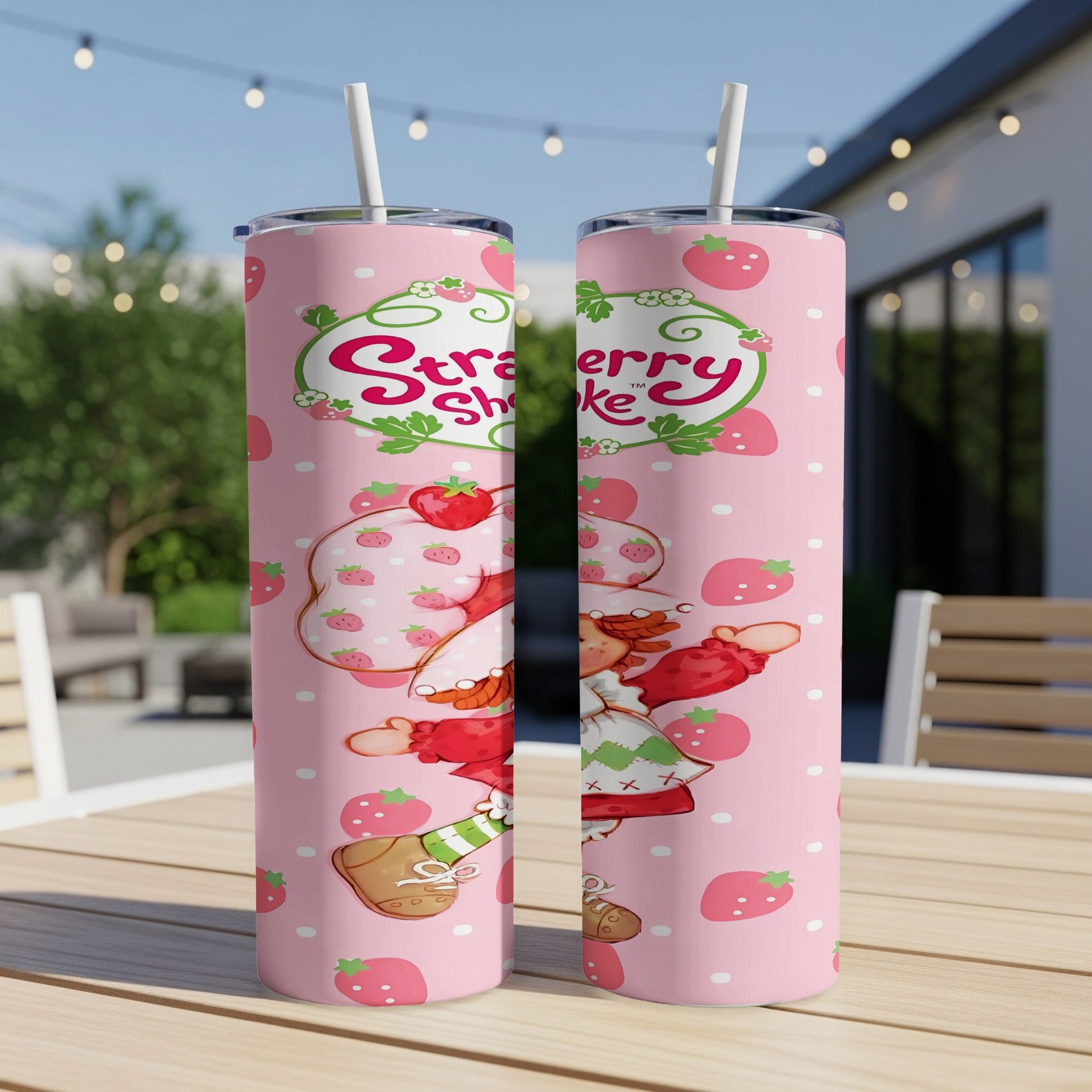 Strawberry Shortcake character on a pink patterned tumbler with strawberries.