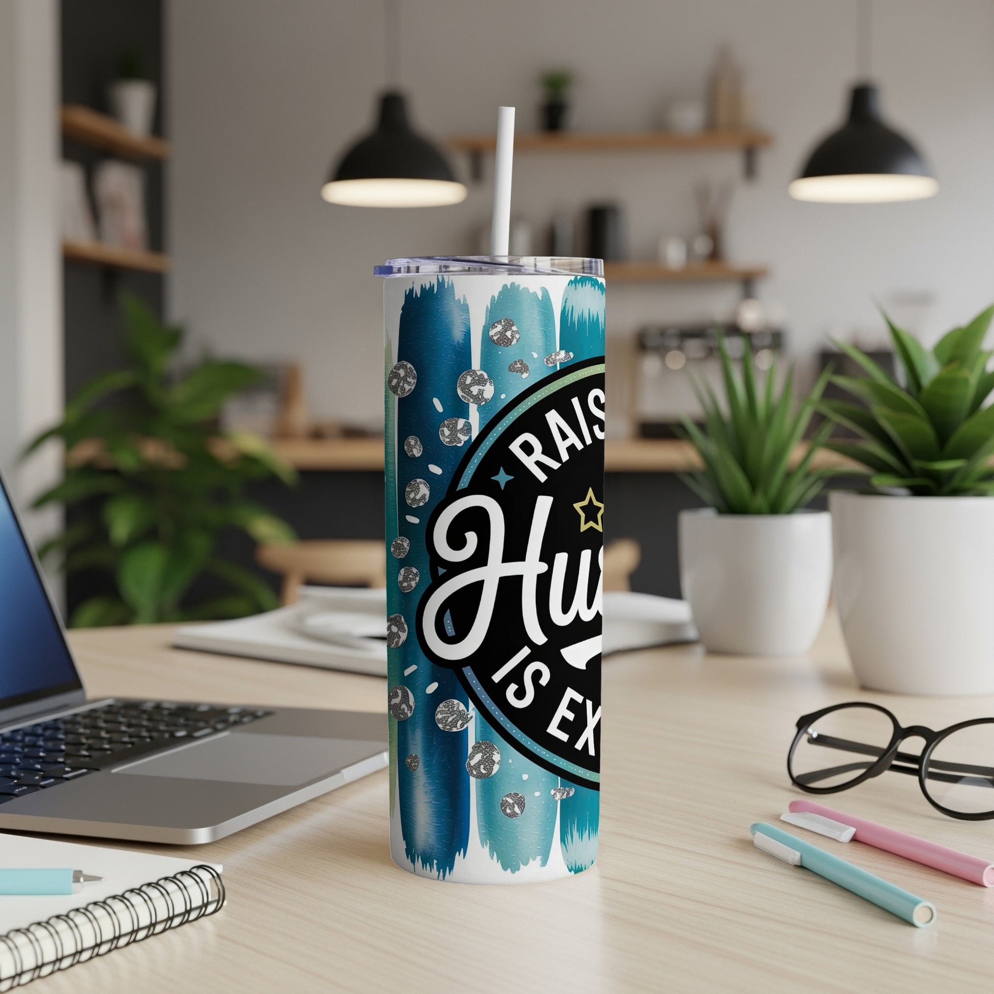 Blue and white striped tumbler with "Raised Hustle is Everything" text and glitter details.