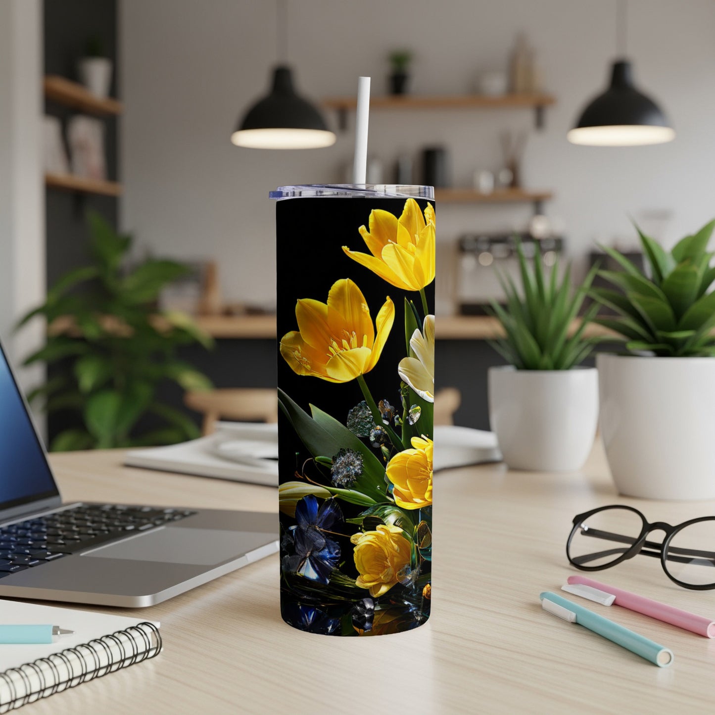 Tall tumbler with yellow tulips and dark floral pattern on black background.