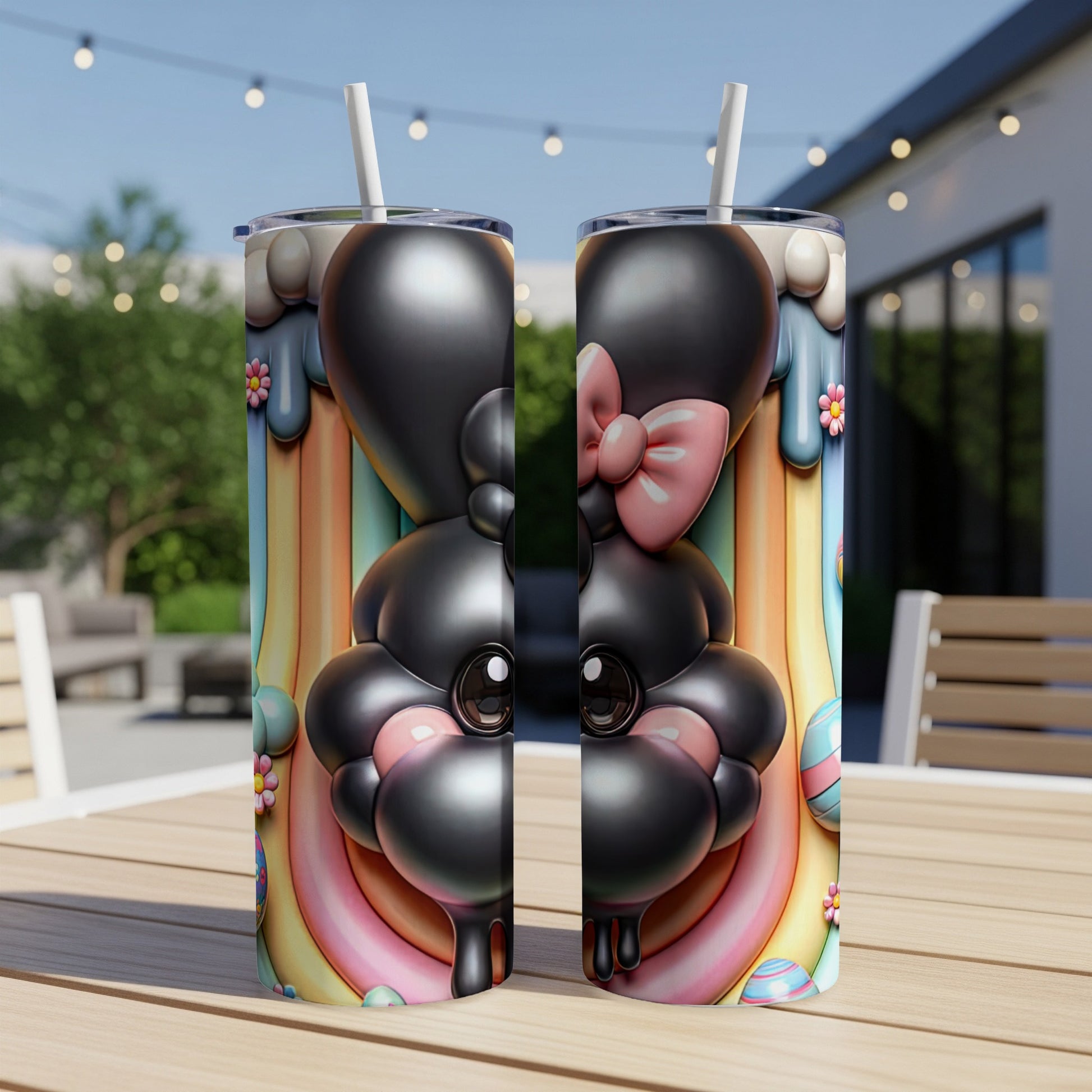 Two cartoon bunny tumblers with rainbow and Easter egg designs.