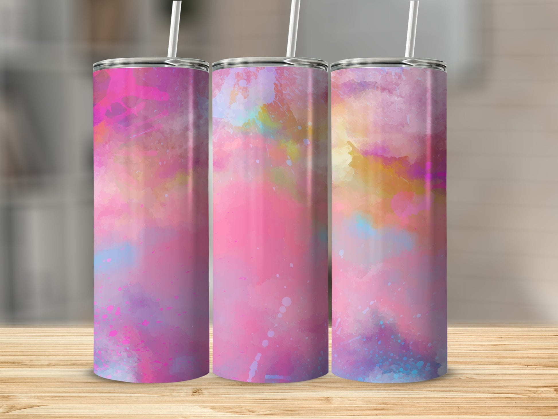 Three tall tumblers with pink, purple, and blue watercolor designs.