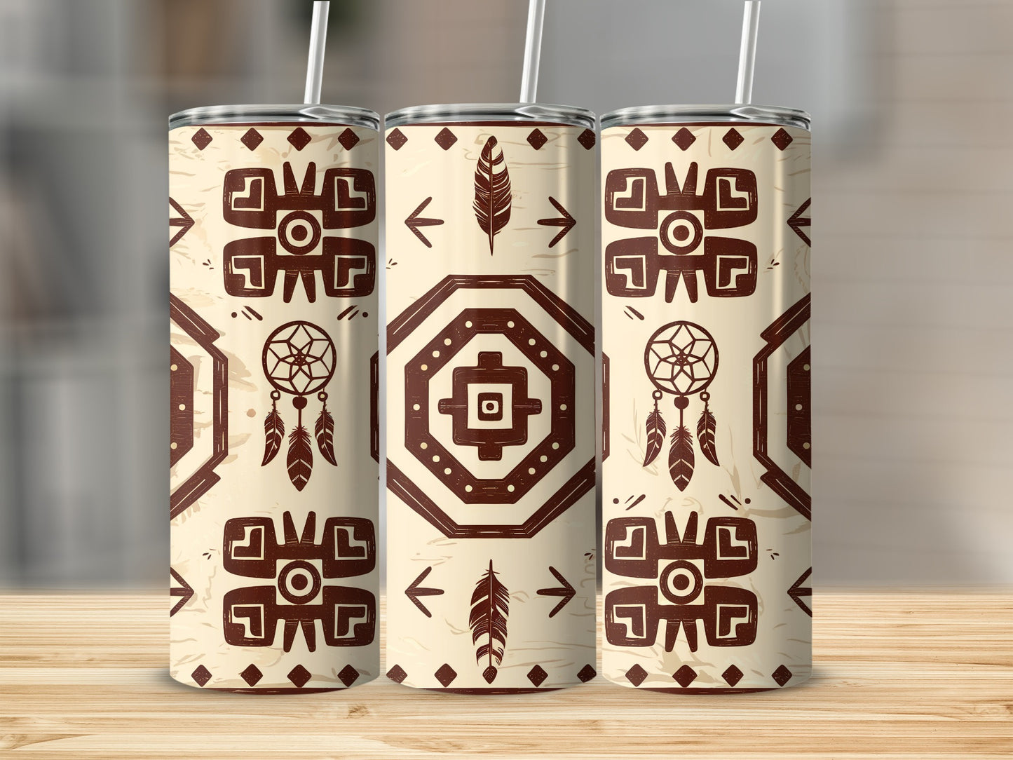 Three tumblers with a geometric native-inspired pattern and feathers.