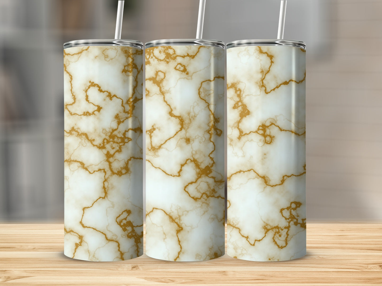 Three tall tumblers with a white and gold marble pattern and straws.