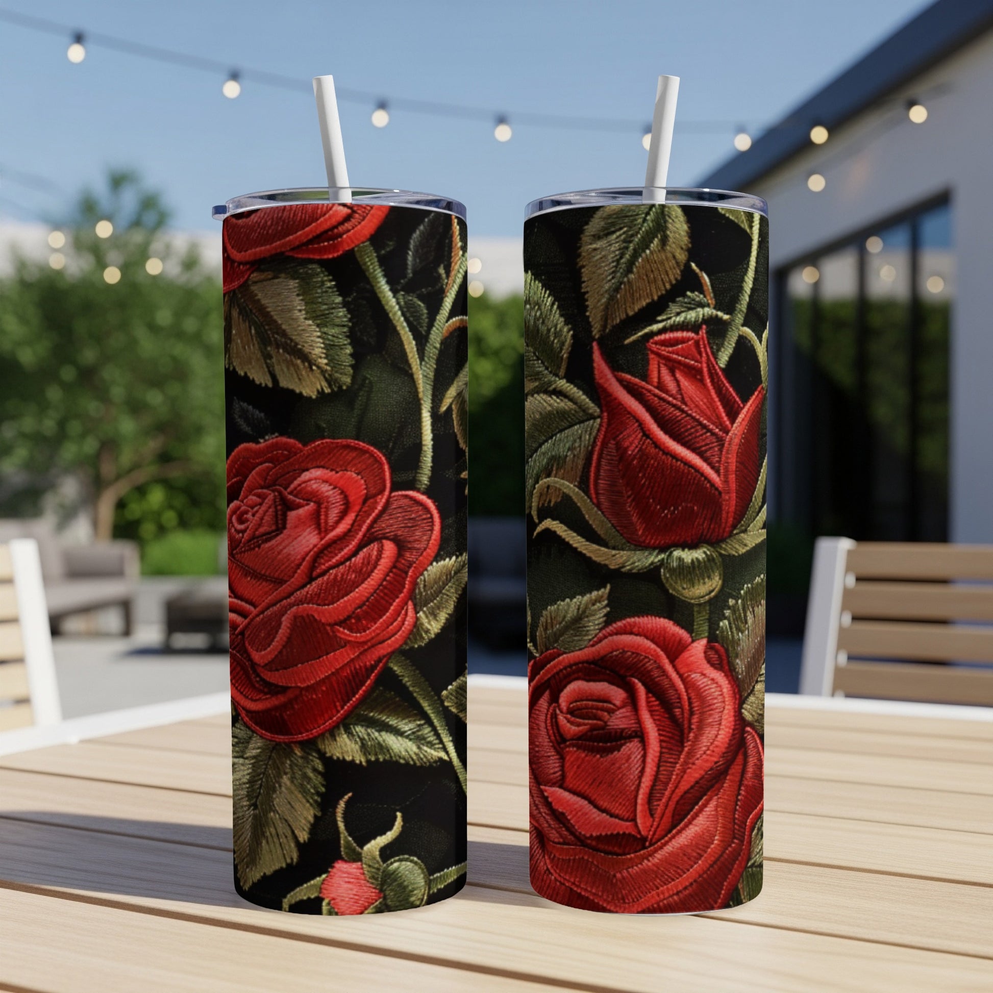 Two tumblers with detailed embroidered red roses on a dark background.