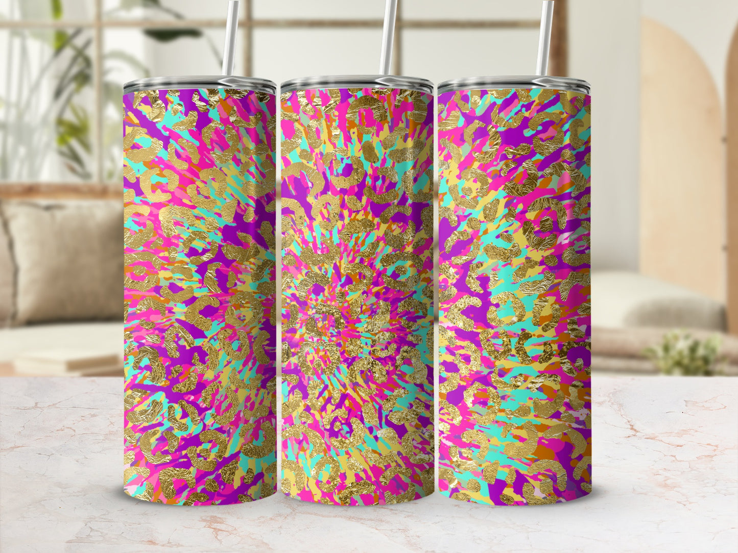 Three tumblers with a gold leopard print on a purple, pink, and turquoise background.