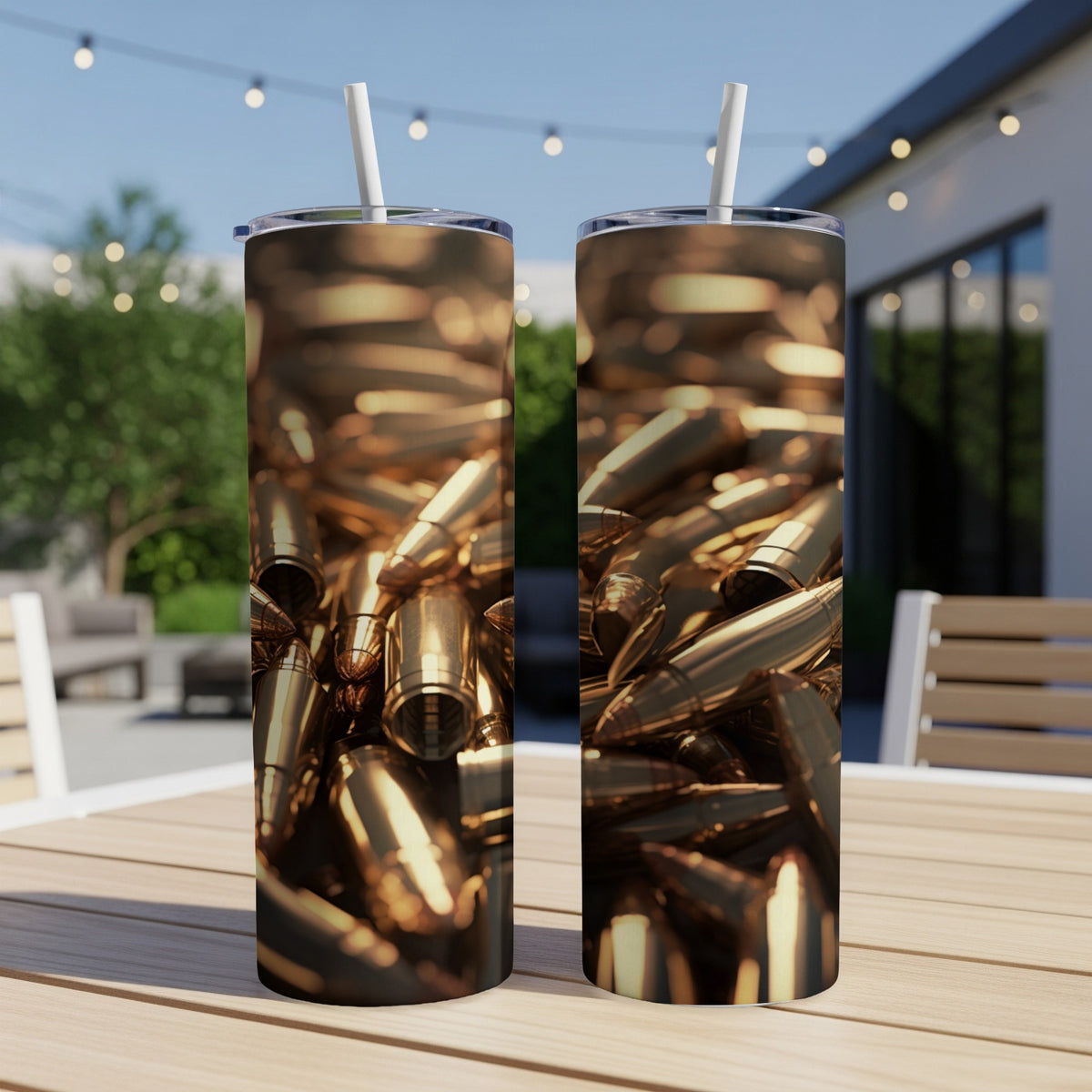 Two tumblers with a close-up pattern of golden bullet casings on an outdoor table.