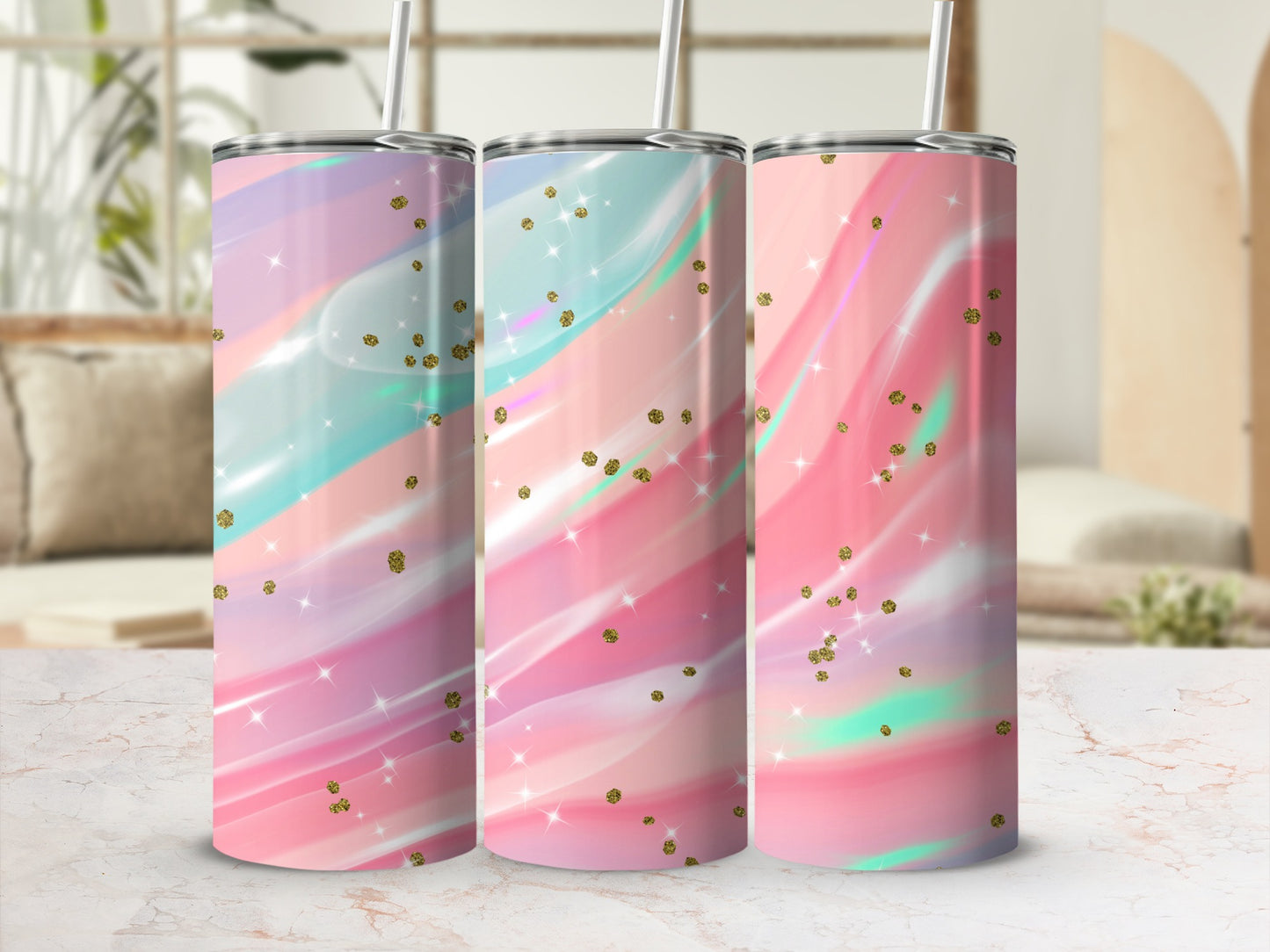 Three tumblers with pastel watercolor designs and gold glitter accents.