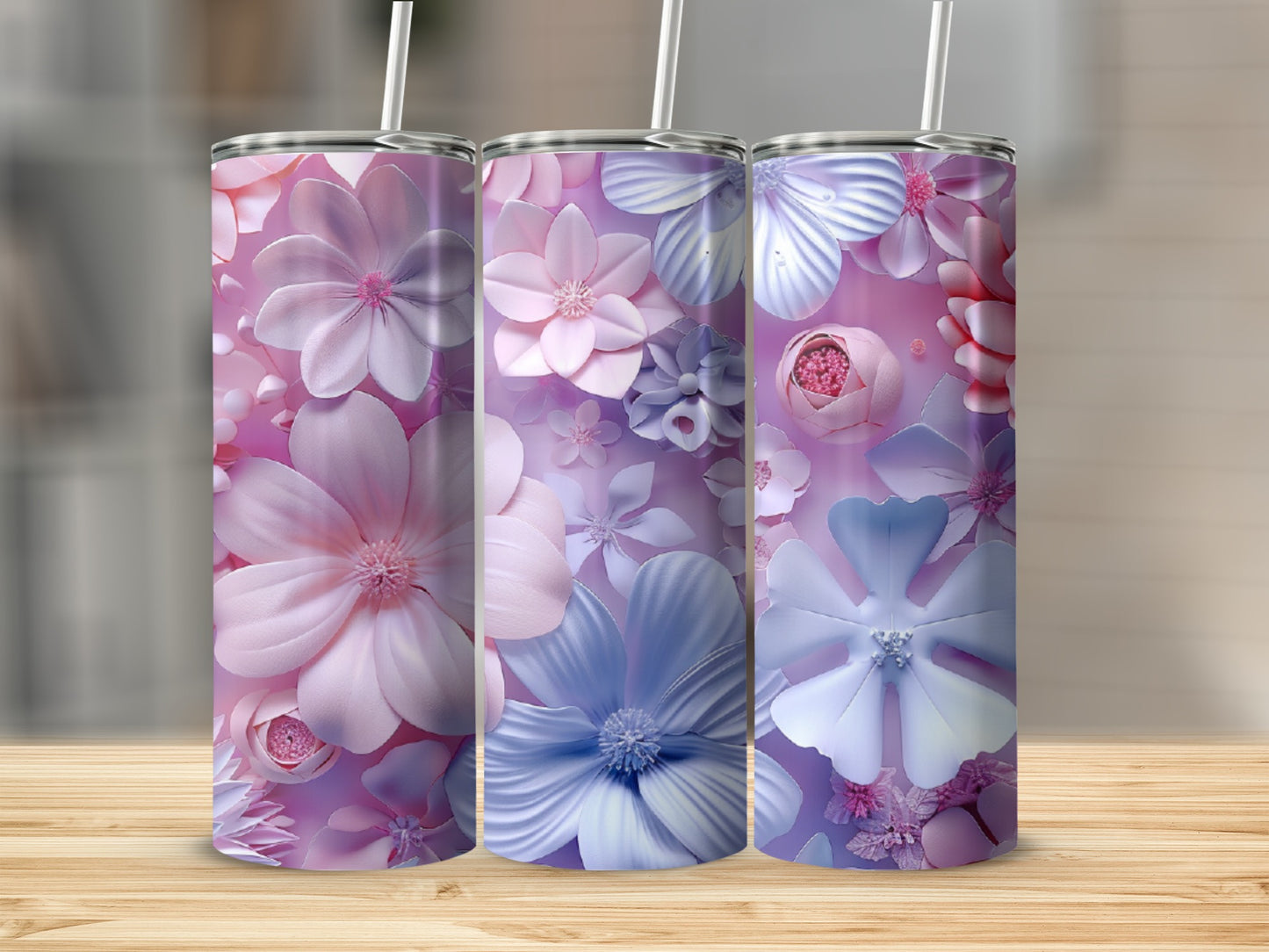 Three tumblers with a floral pattern in pink and blue hues.