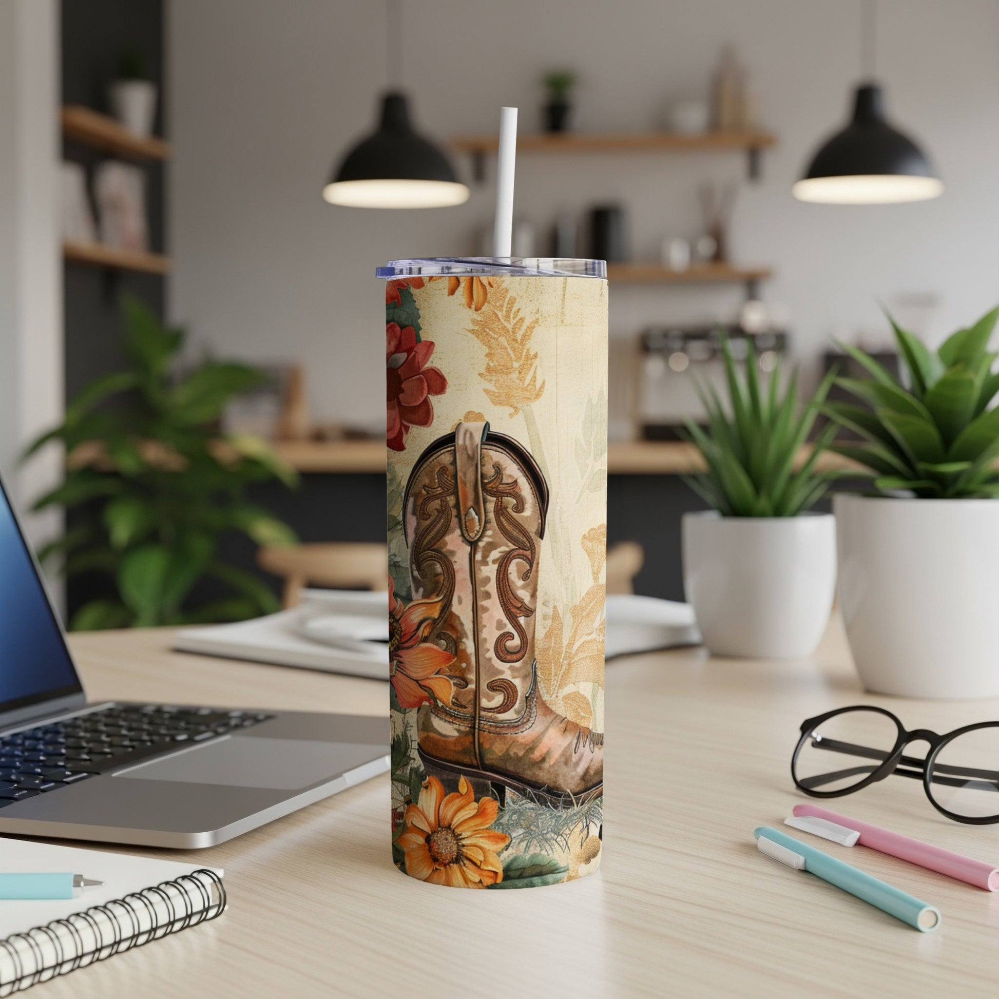 Cowboy boot and floral pattern on a white tumbler with a straw.