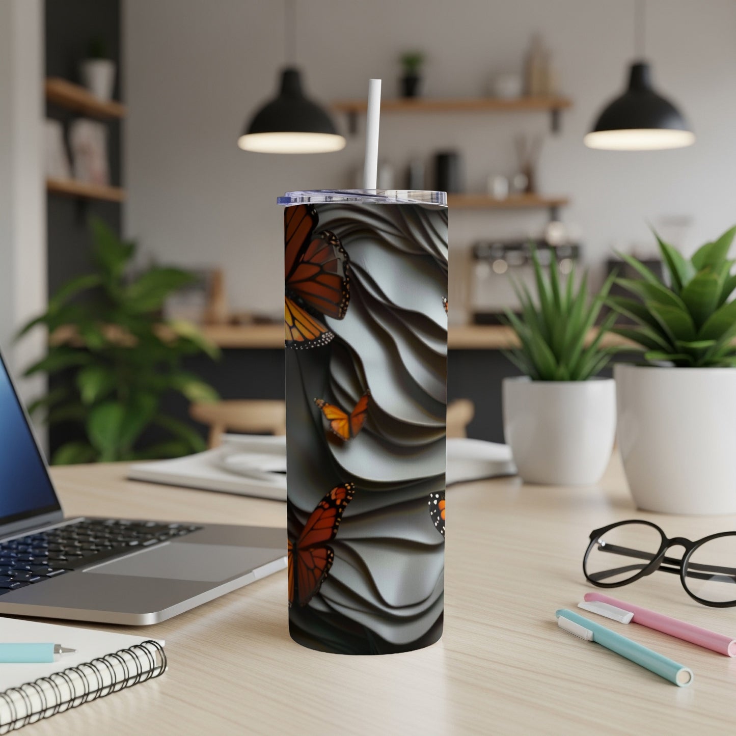Tall tumbler with monarch butterflies and a wavy pattern.