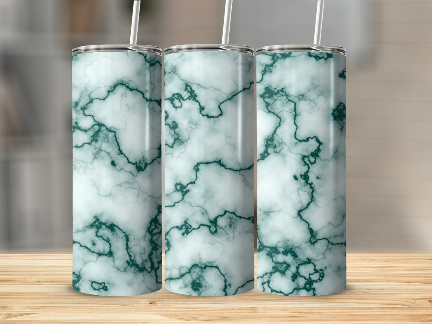 Three tumblers with a teal and white marble pattern and straws.