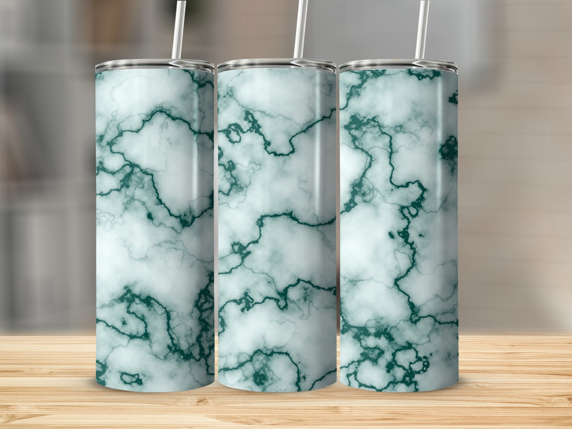 Three tumblers with a teal and white marble pattern and straws.