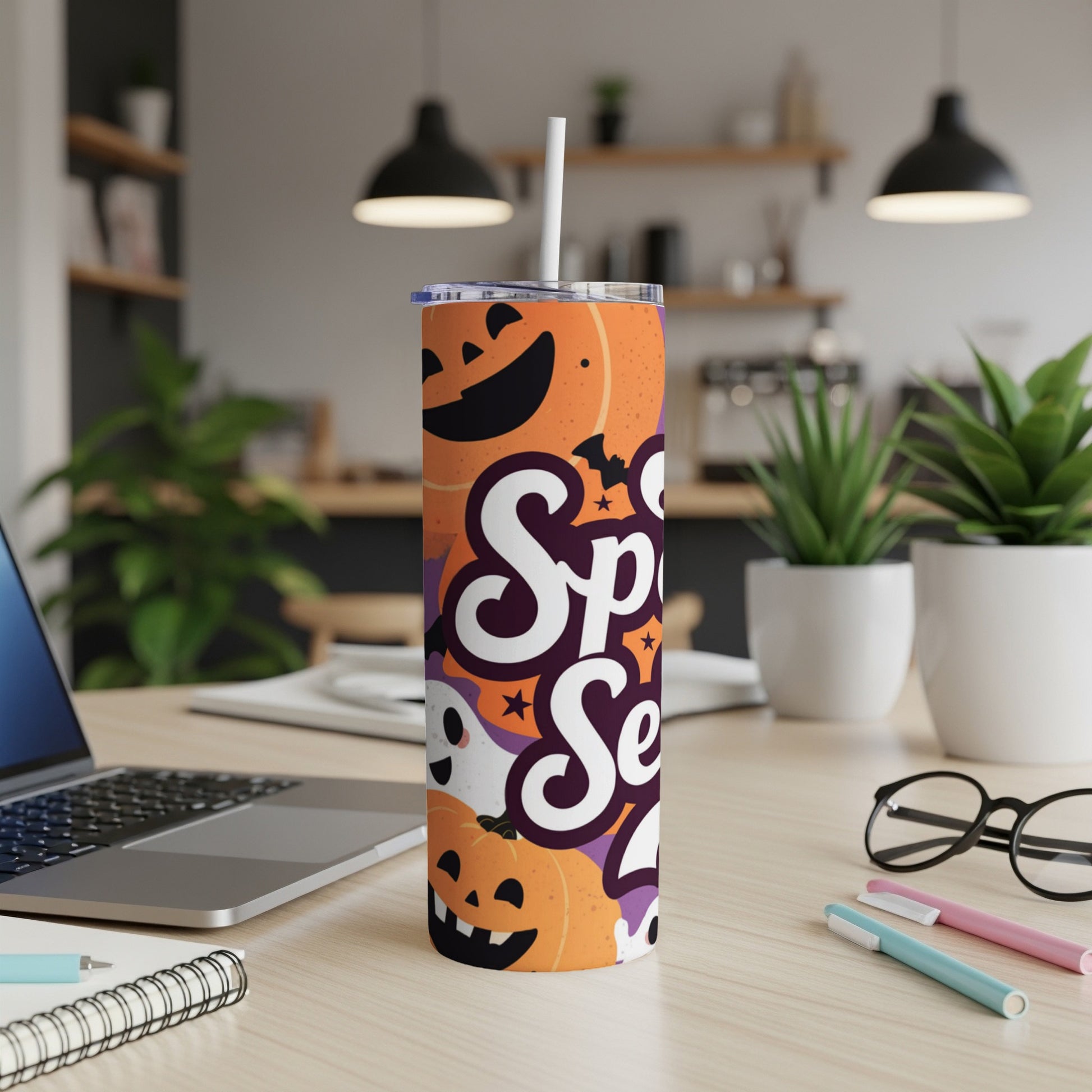Orange tumbler with Halloween pattern and text "Spooky Season".