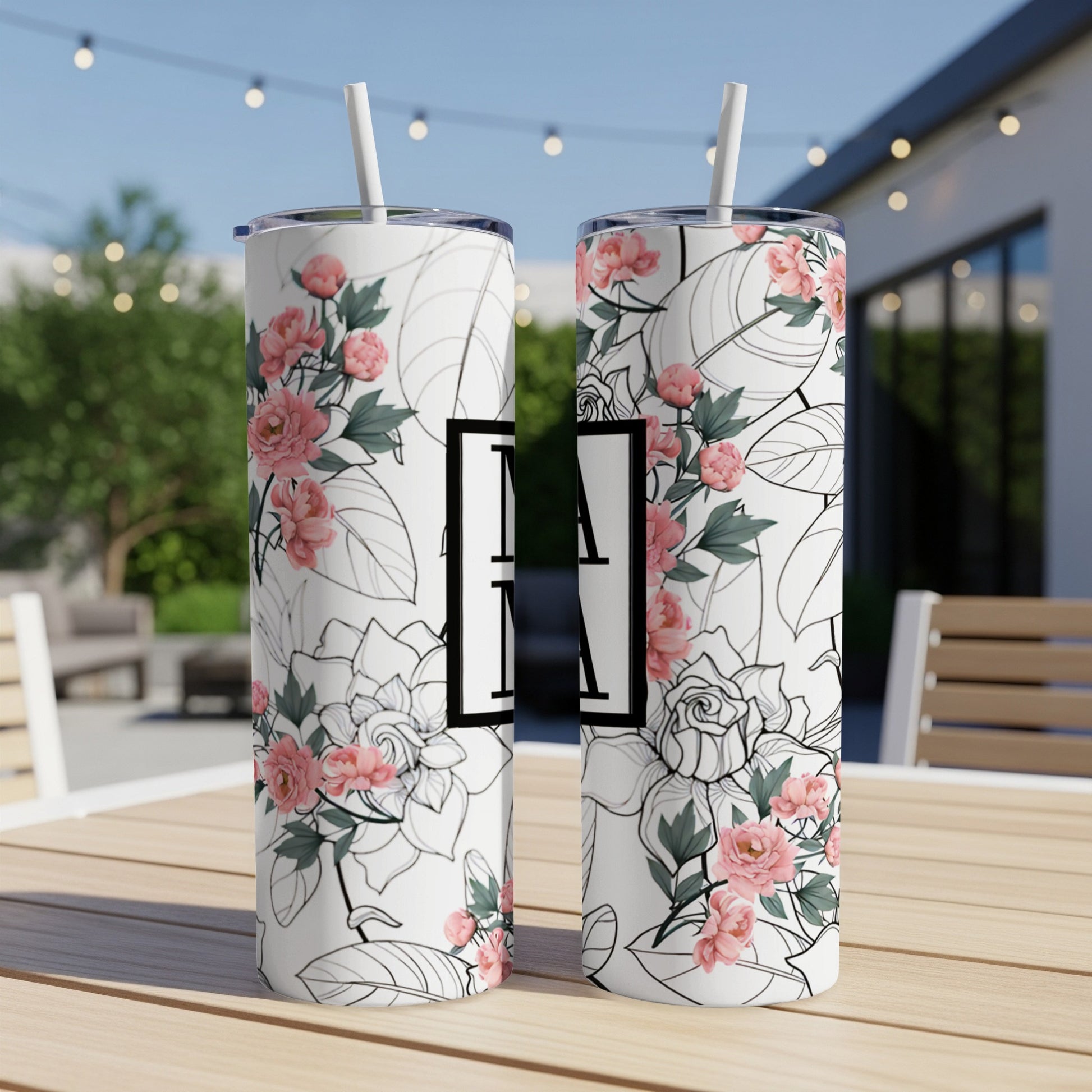 Two tall tumblers with floral pattern and large white "MA" initial.