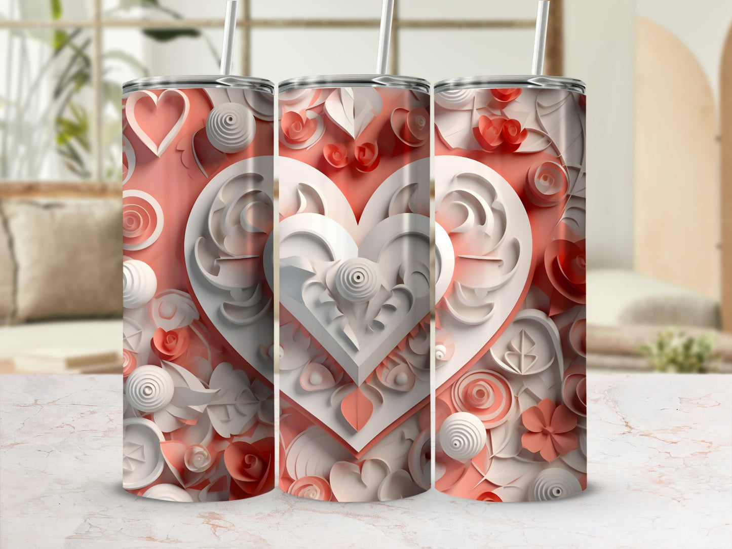 Three tumblers with intricate floral heart designs and pink and white details.