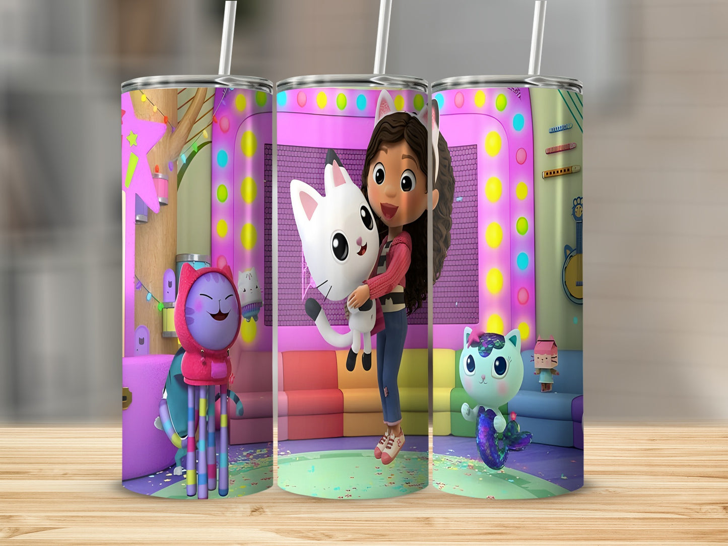 Gabby's Dollhouse characters Gabby, Pandy Paws, and MerCat on a colorful, animated background.