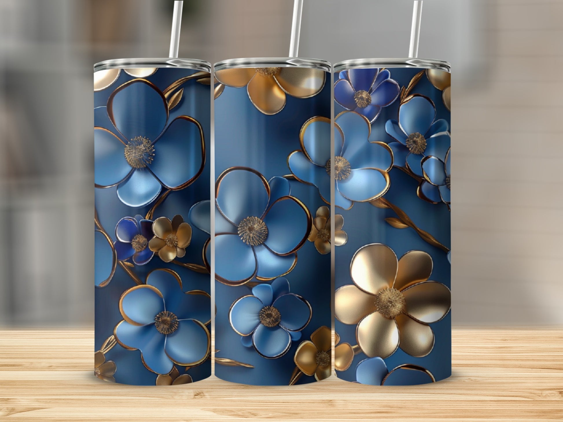 Three blue tumblers with gold and blue floral designs.